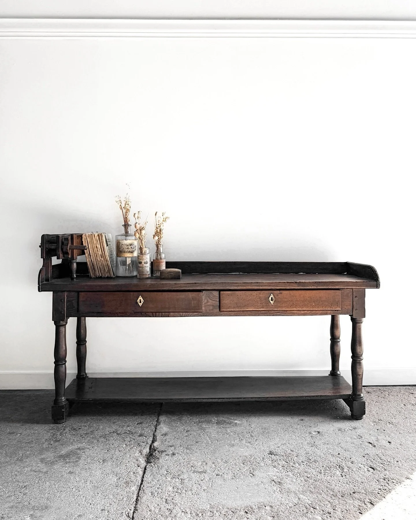 A statement without trying. ✨

Once used to roll cigars in Belgium, this oak + walnut work table wears its history beautifully&mdash;deep patina, hand-turned legs, smooth drawers, and a handmade press with forged iron teeth.

A soulful, sculptural co