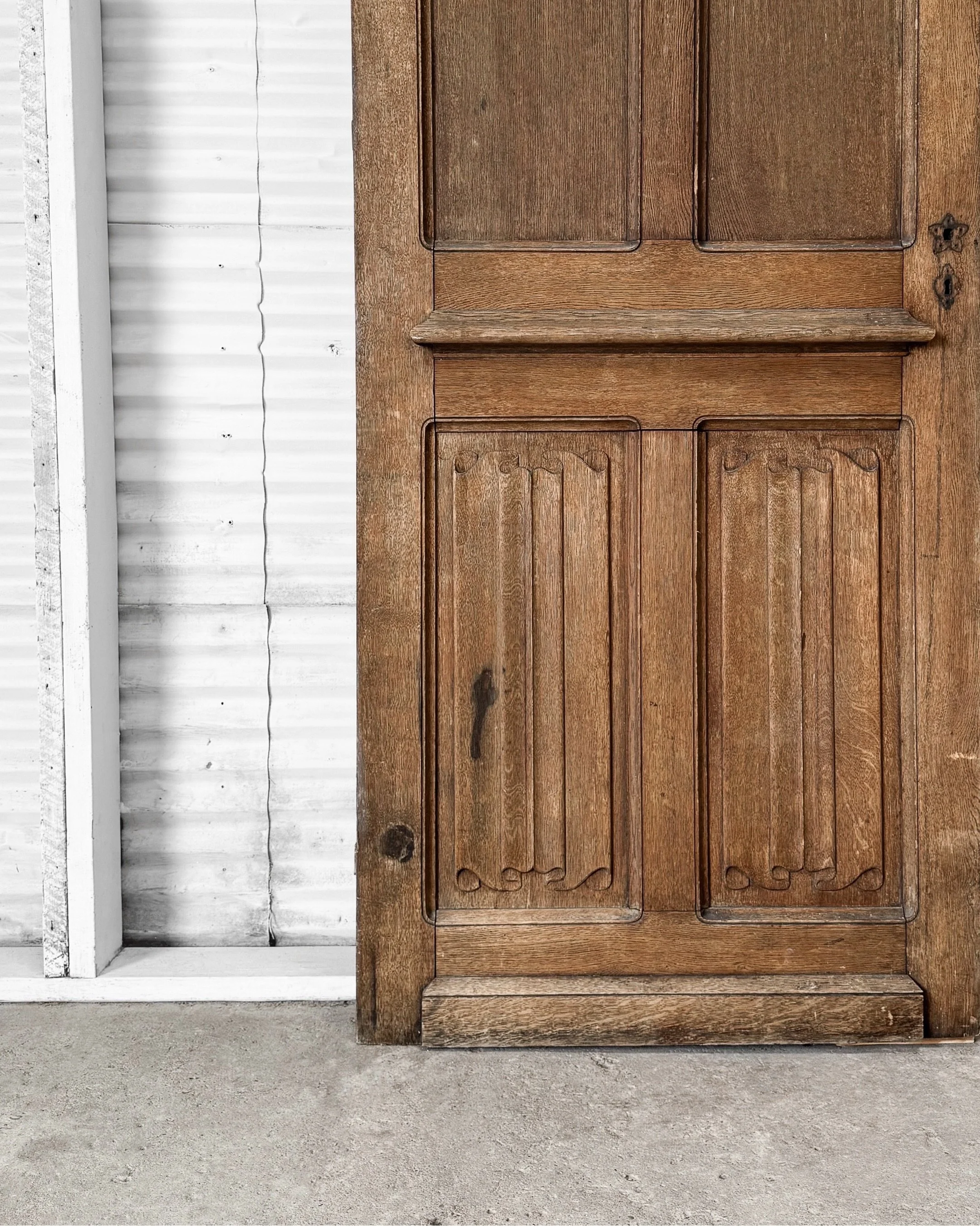 Some doors are meant to be opened. This one is meant to be noticed.

A 19th-century French walnut door with carved napkin-fold panels on one side and timeworn blue-gray paint on the other. At just over 8 feet tall, he&rsquo;s not exactly the shy, ret