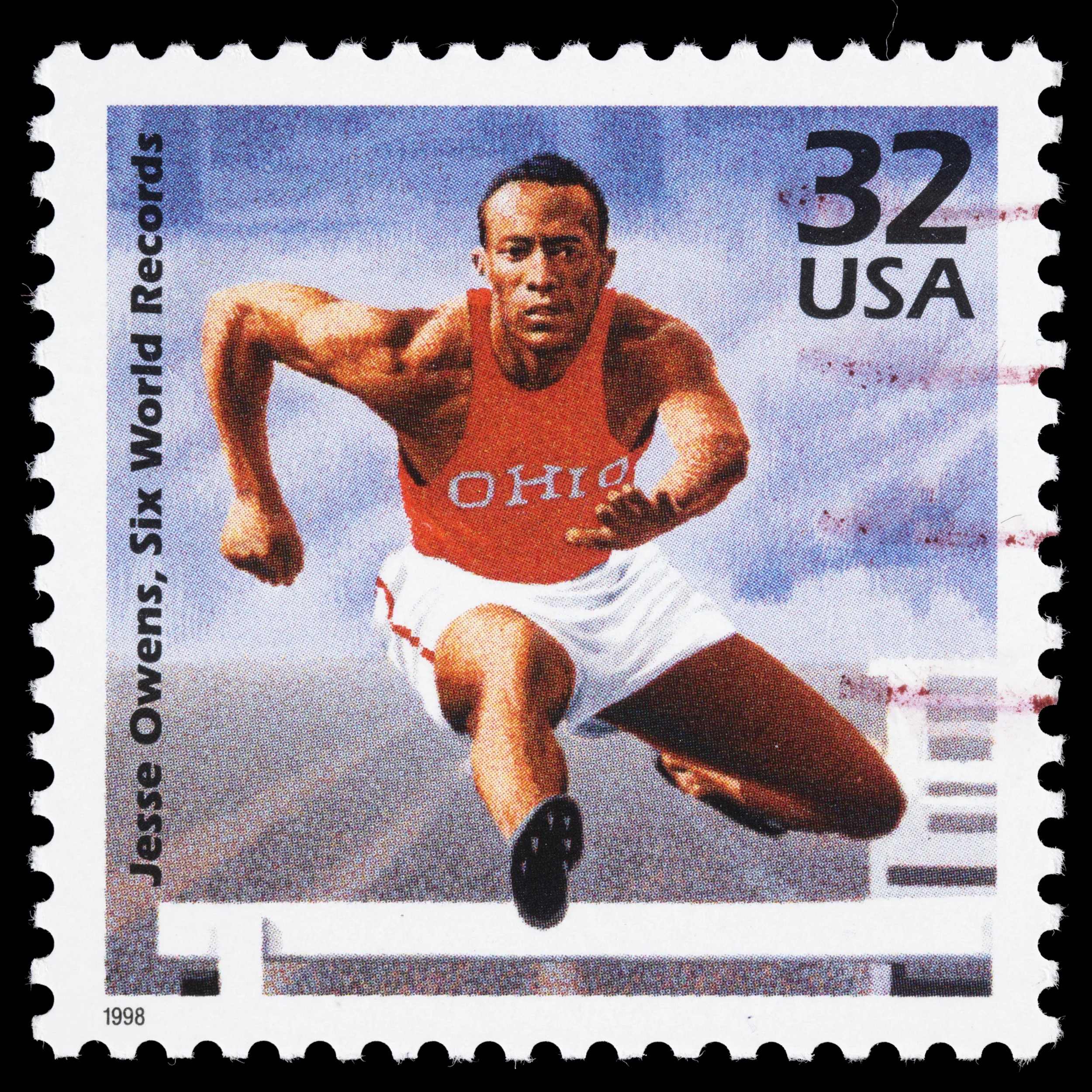 Jesse Owens wins his first of four gold medals in Berlin
