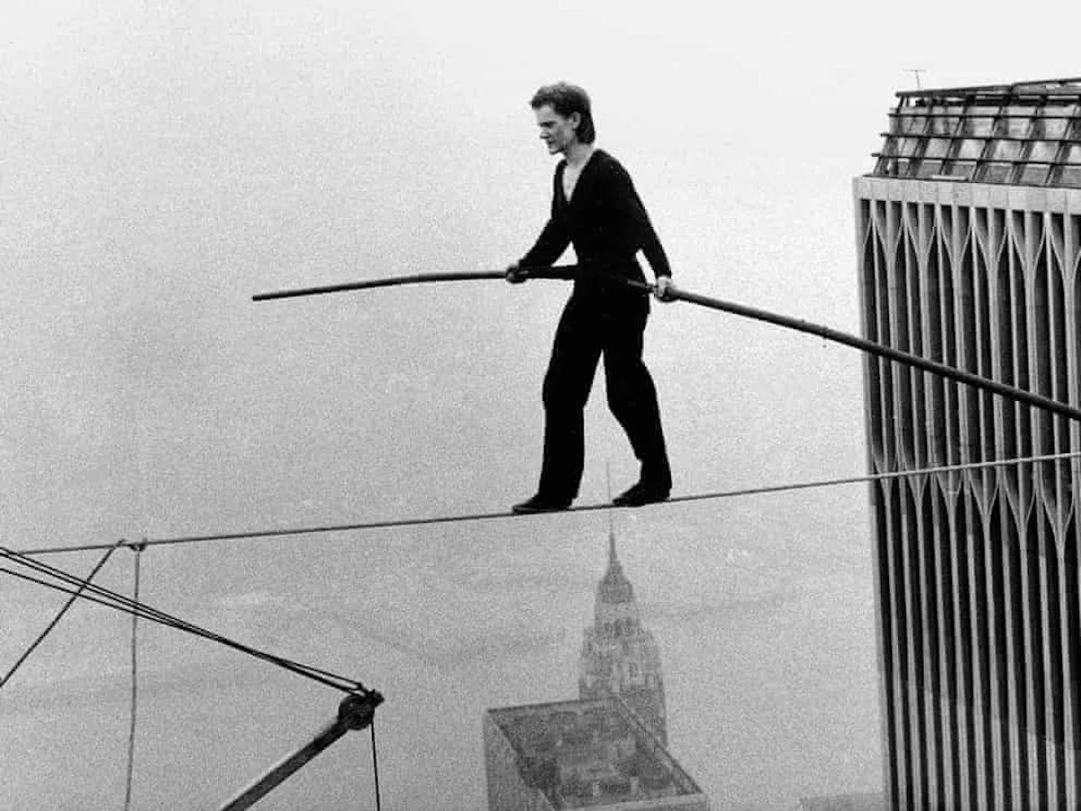 Philippe Petit walks on a tightrope between the Twin Towers