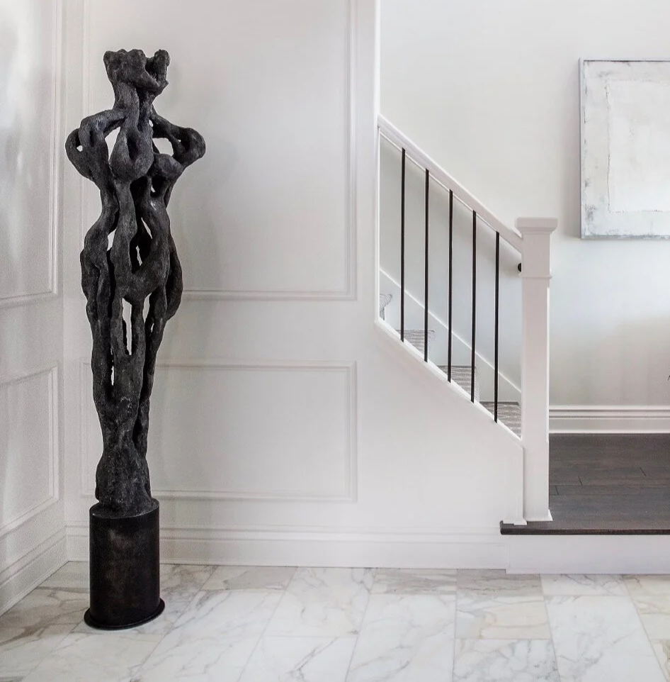 a black plaster sculpture of an abstract woman by RILEY RIDD in an Anne Marie Barton designed entryway