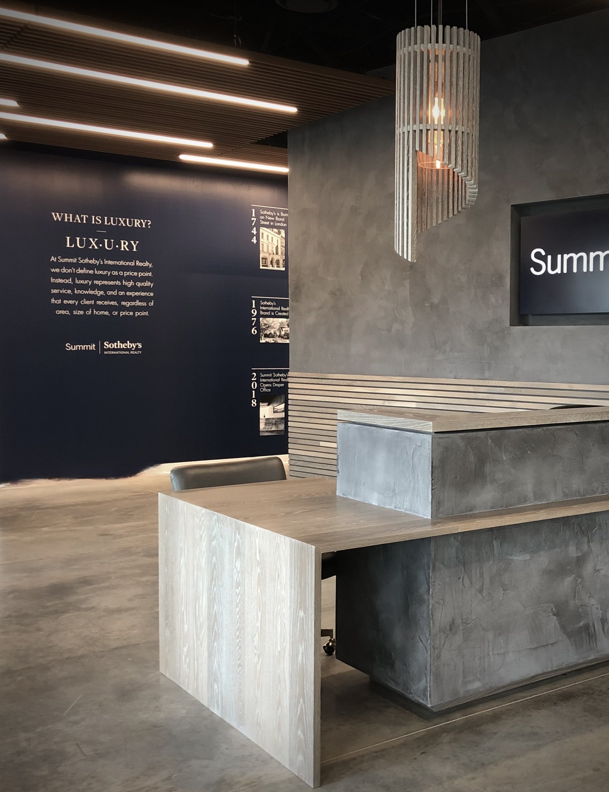 summit Sothebys custom light fixture plaster reception desk Slc utah commercial design