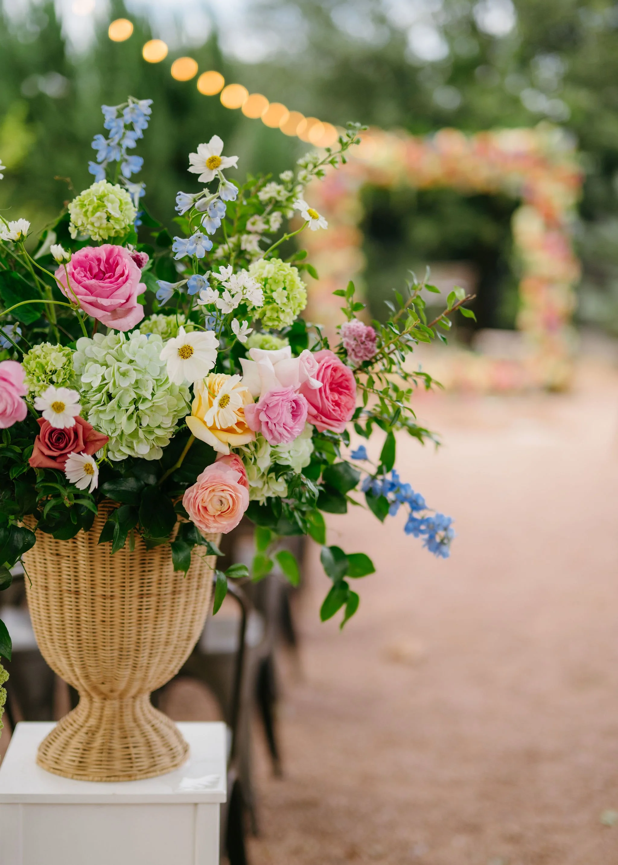 Trending wicker urn design created by Central Texas wedding florist team