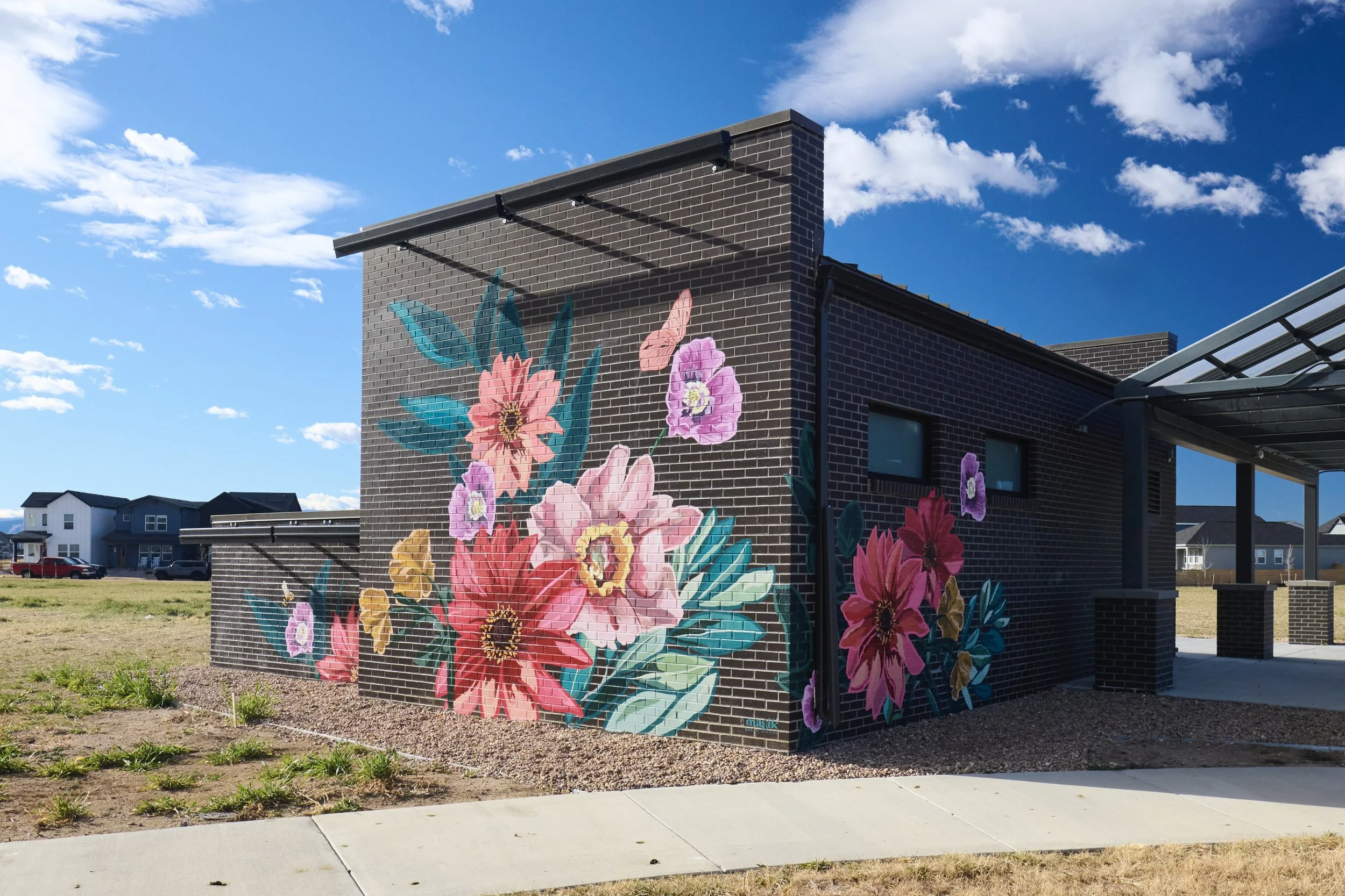Large-scale floral mural on Bloom amenity building by Magik Studios in Fort Collins, Colorado