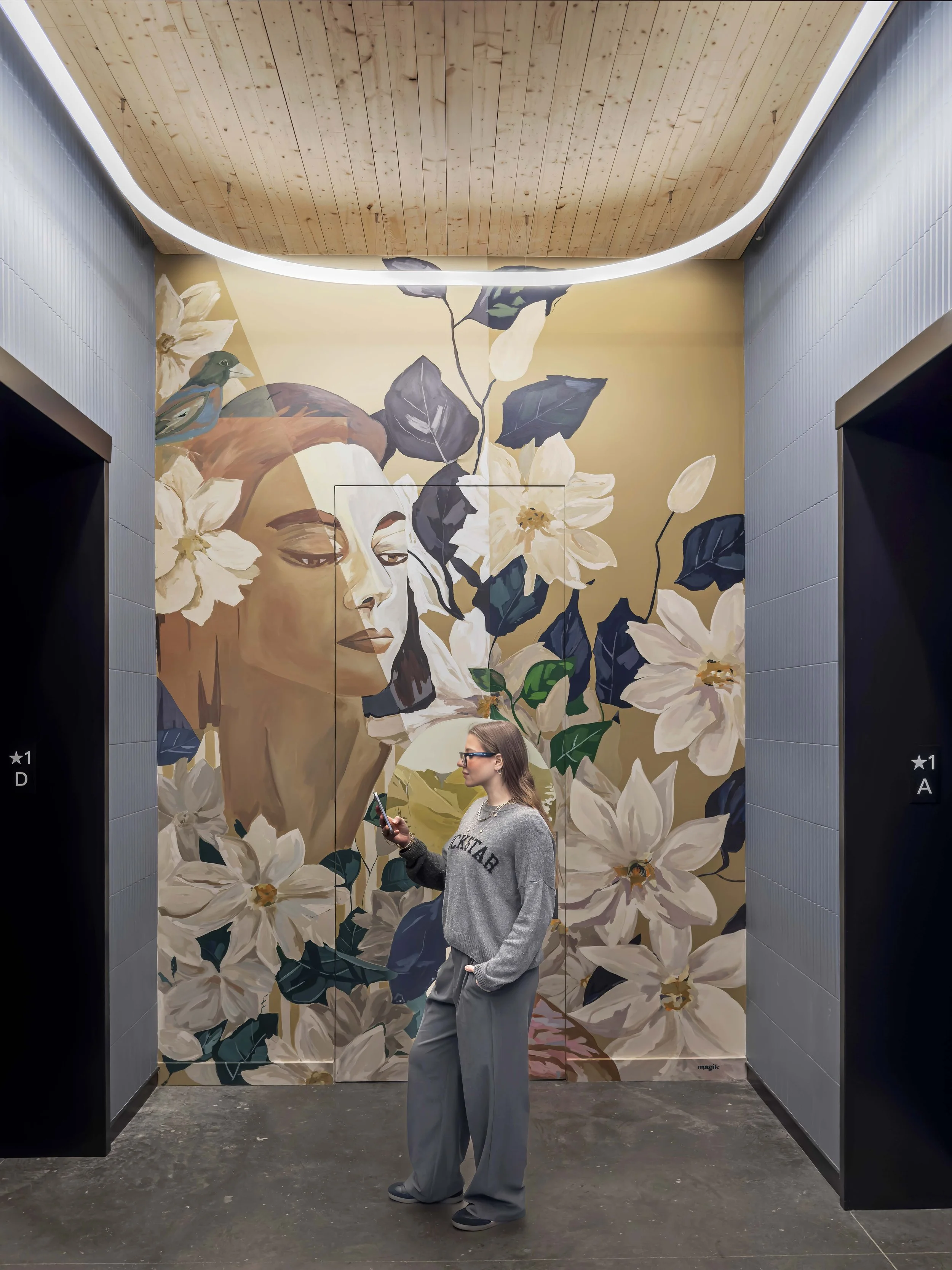 Female figure floral mural at T3 RiNo office lobby by Magik Studio in Denver, Colorado