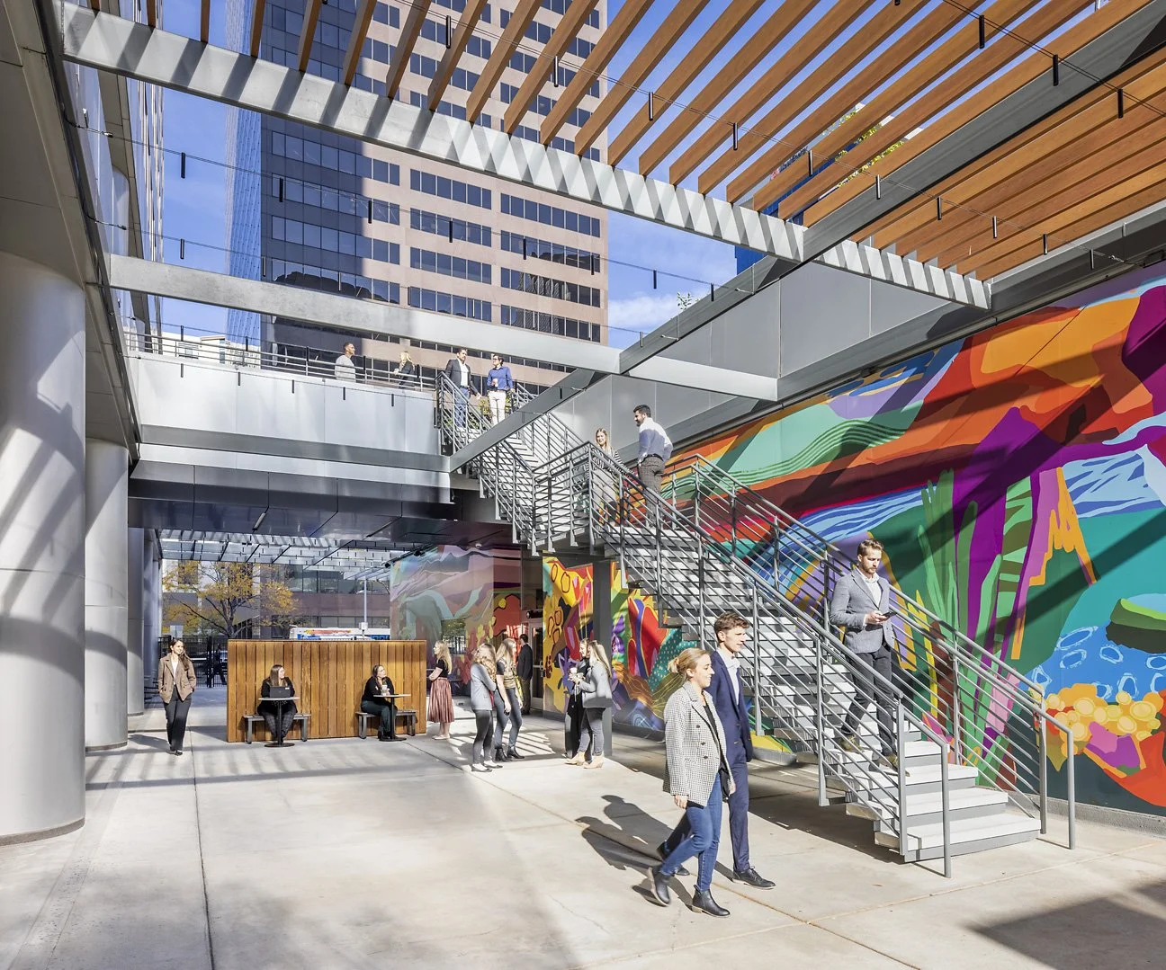 Vinyl mural building wrap of vibrant abstract landscape at 17th Street in Denver, Colorado by Magik Studios