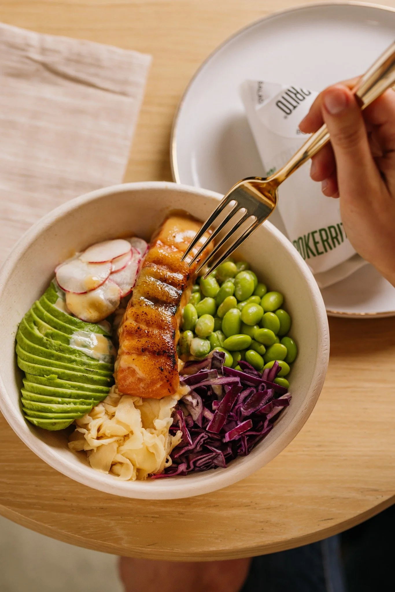 Torched salmon bowl with avocado, edamame, radish and purple cabbage at Pokerrito.