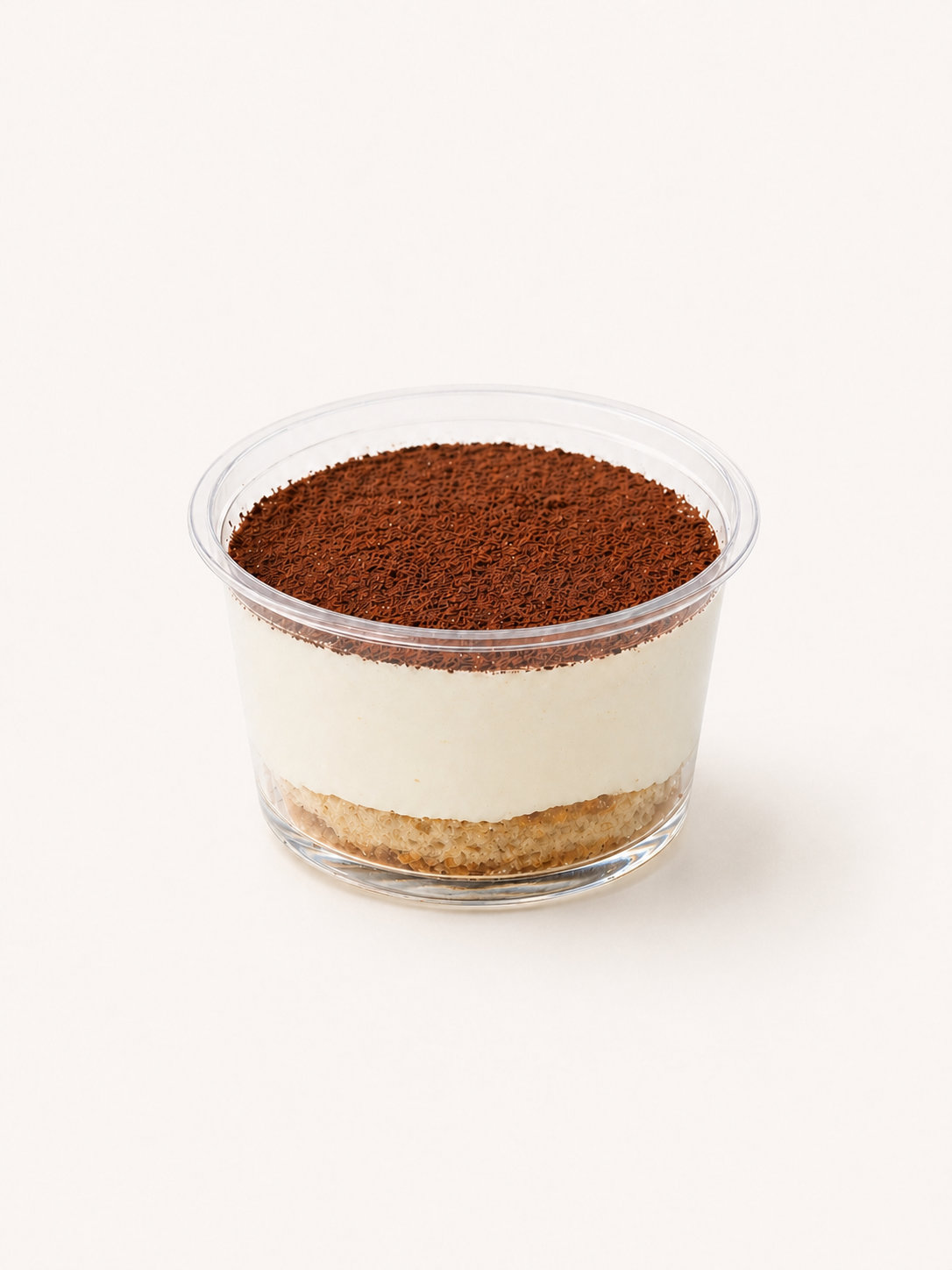 Layered tiramisu dessert in a clear plastic cup with cocoa powder and chocolate sprinkles on top.
