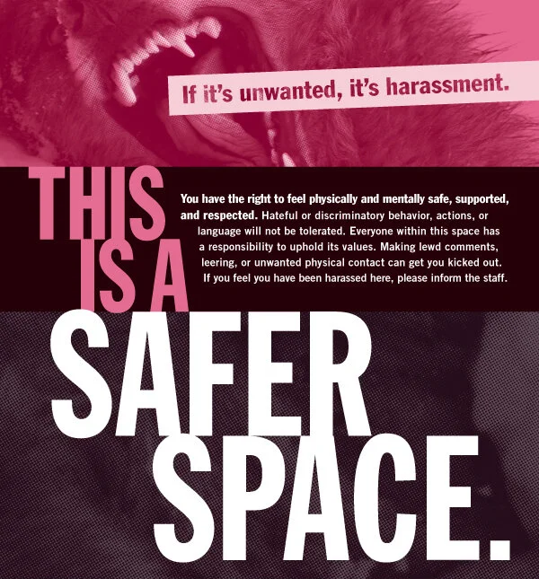 sign reading "if it's unwanted, it's harassment. this is a safer space"
