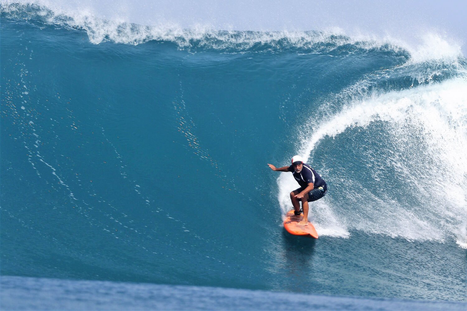 73-year-old surfer Joseph Grassadonia carving a powerful turn on a wave at Sunset Beach, Hawaii.
