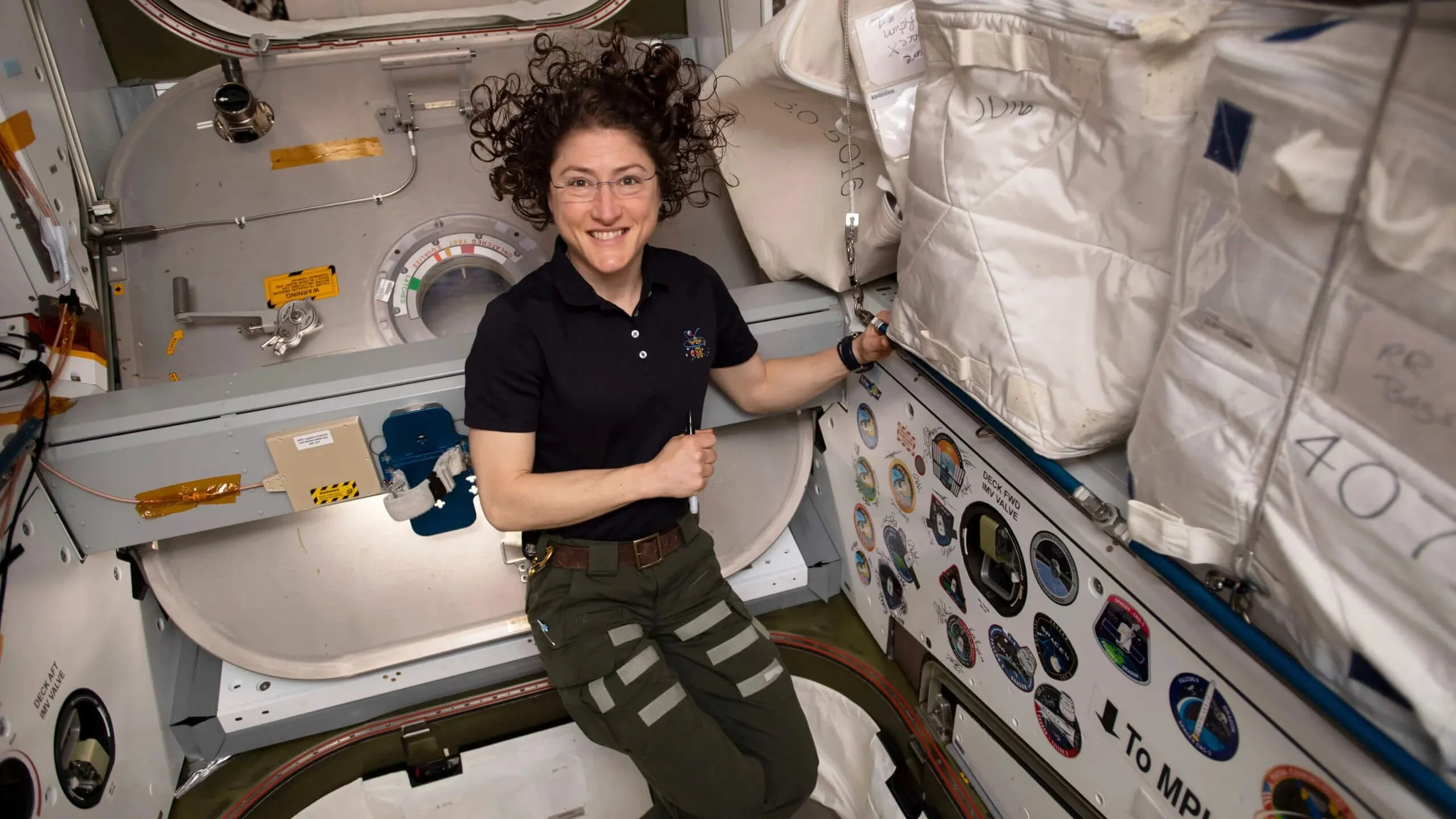 Christina Koch floating inside the International Space Station during her long-duration NASA mission