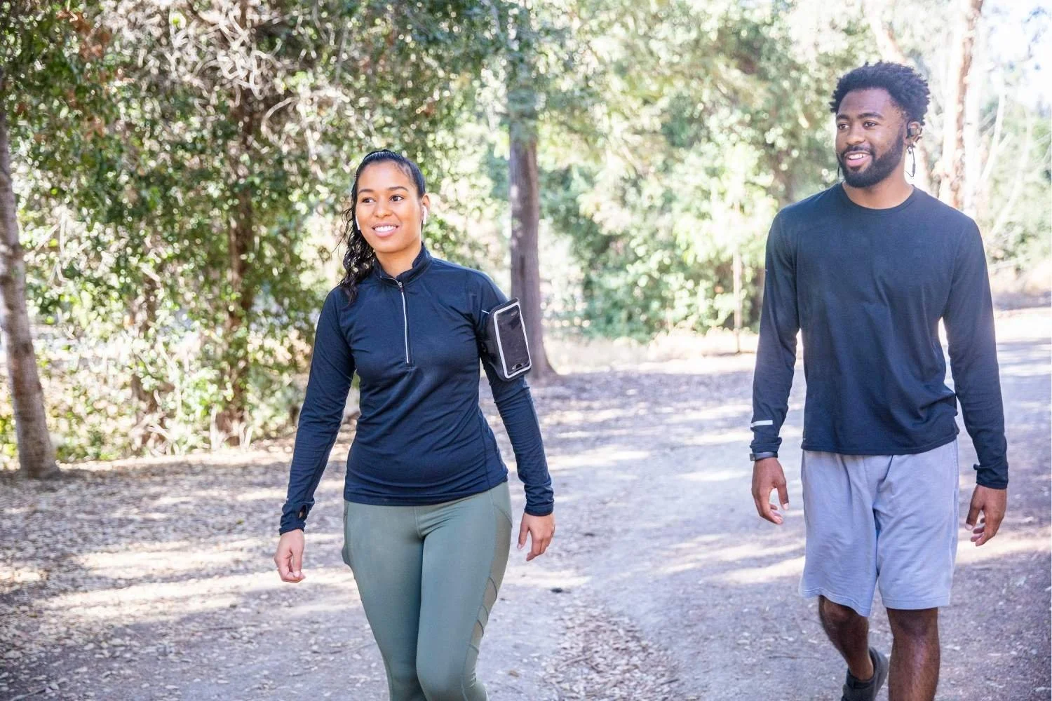 couple walking outside together as part of an active recovery routine.
