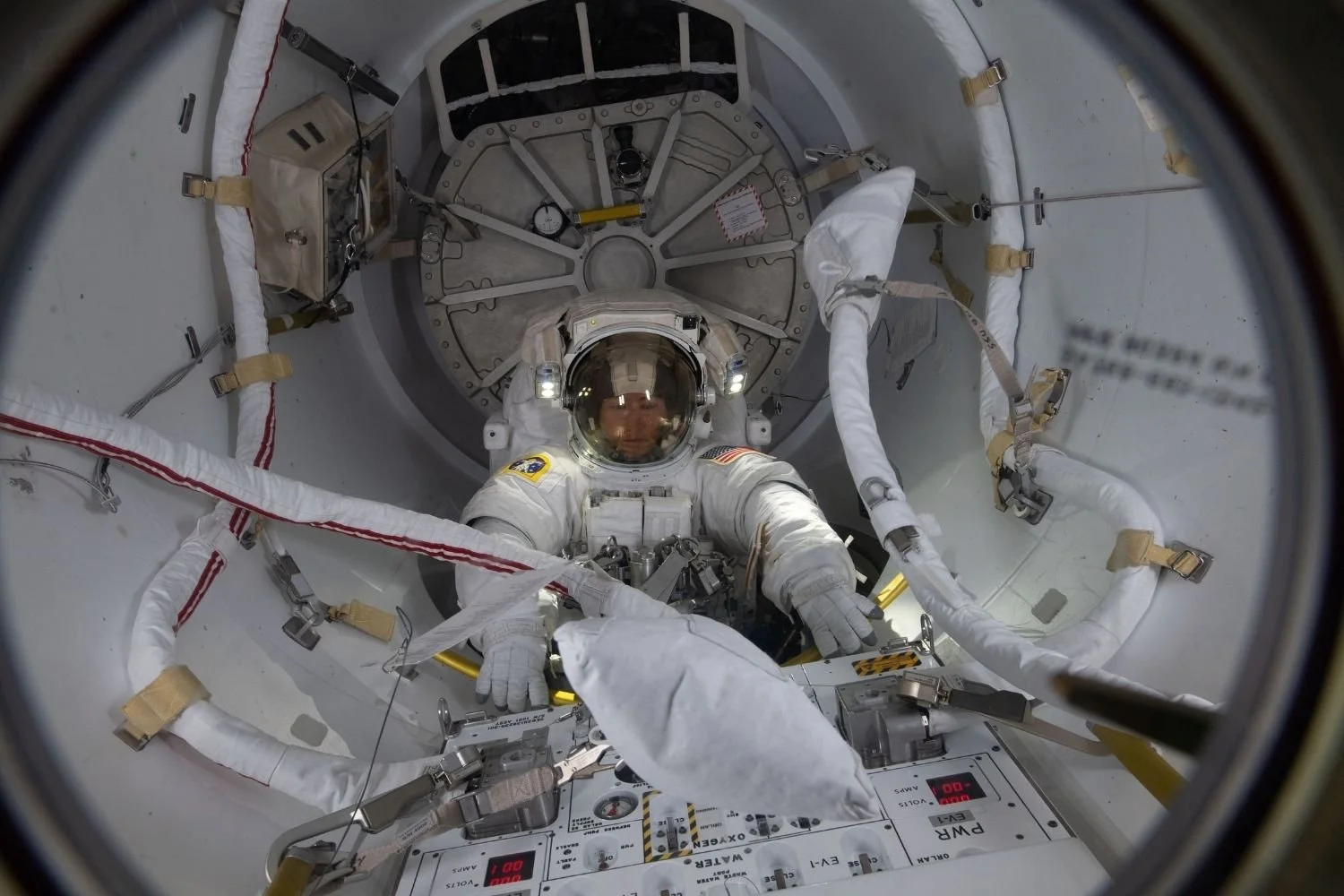 Christina Koch entering the Quest airlock in preparation for a spacewalk on the International Space Station