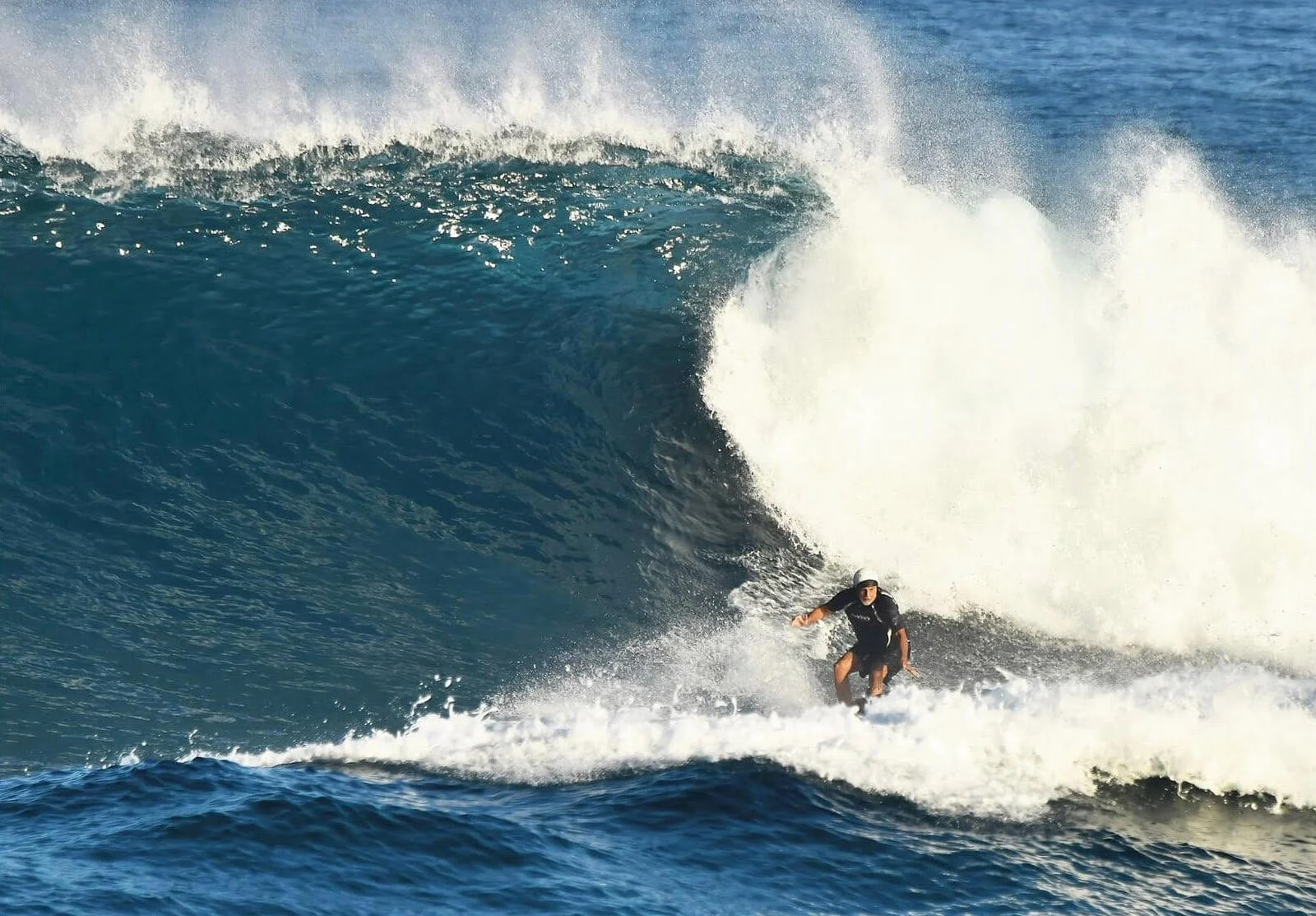 Senior athlete Joseph Grassadonia with his surfboard, illustrating an active longevity lifestyle after 70.