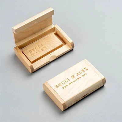 Wooden matchbox with engraved text reading 'Becci & Alex, Our Wedding Day,' next to a closed matchbox with the same inscription.