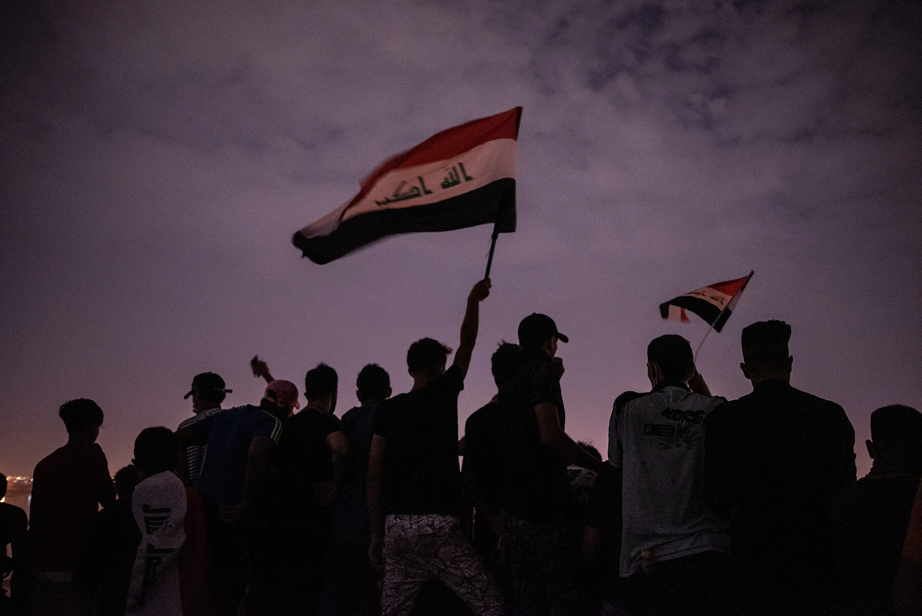   Karrar Nasser  “On the first day of demonstrations in Tahrir Square, people were gathering slowly and I climbed a concrete barrier to take photos. I started filming and moments later saw riot police throw smoke bombs at us. I fell onto the ground w