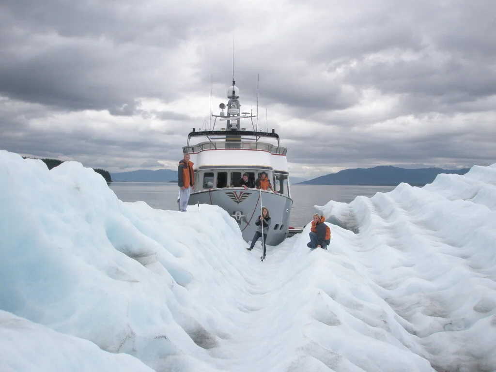 Owners yacht exploring icebergs in Alaska during offshore cruising experience