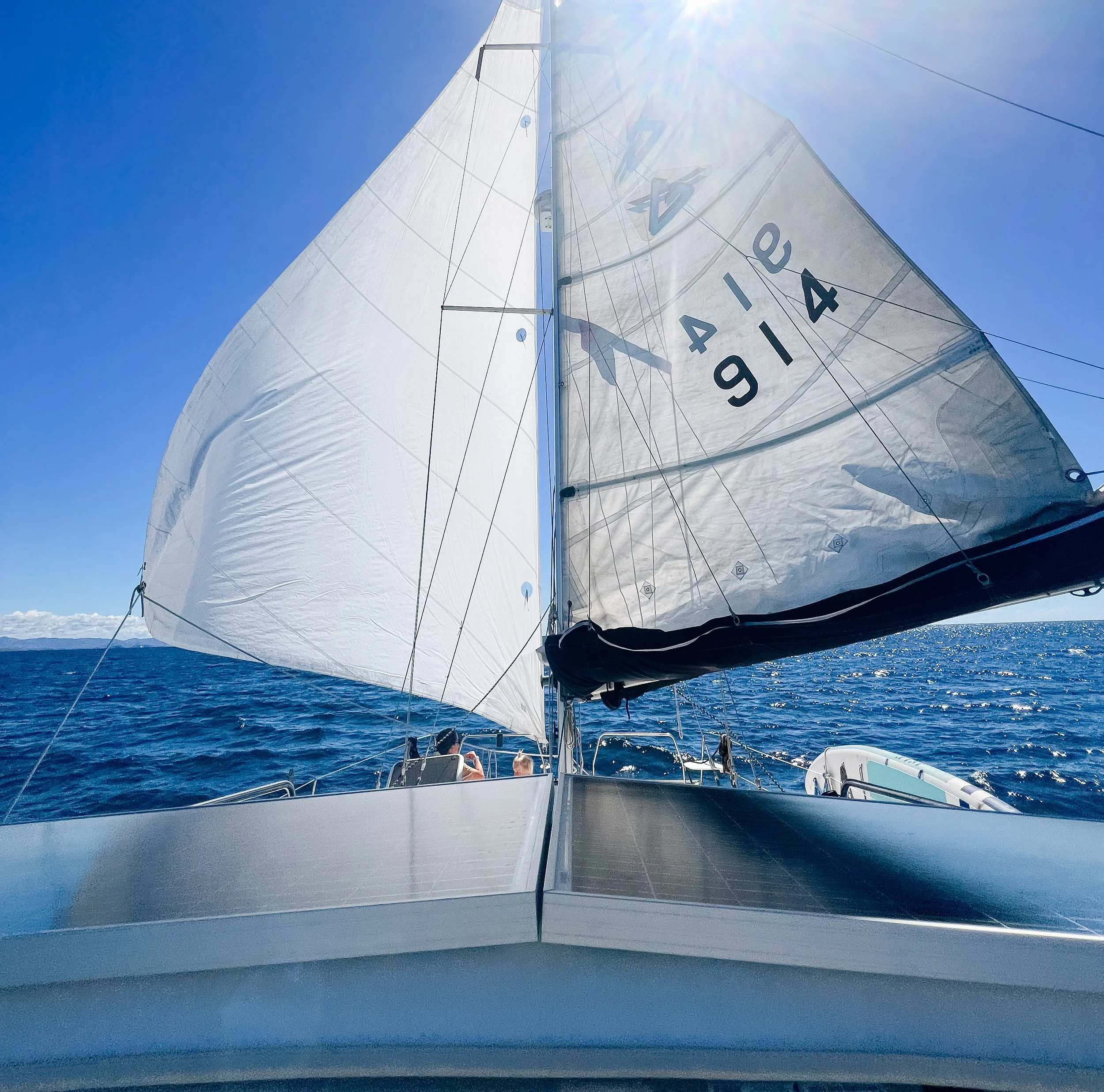 Sailboat cruising offshore along the coast of Mexico