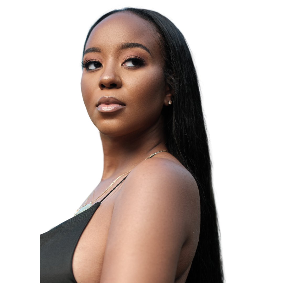Woman with long hair in a black top, looking to the side, against a plain background.