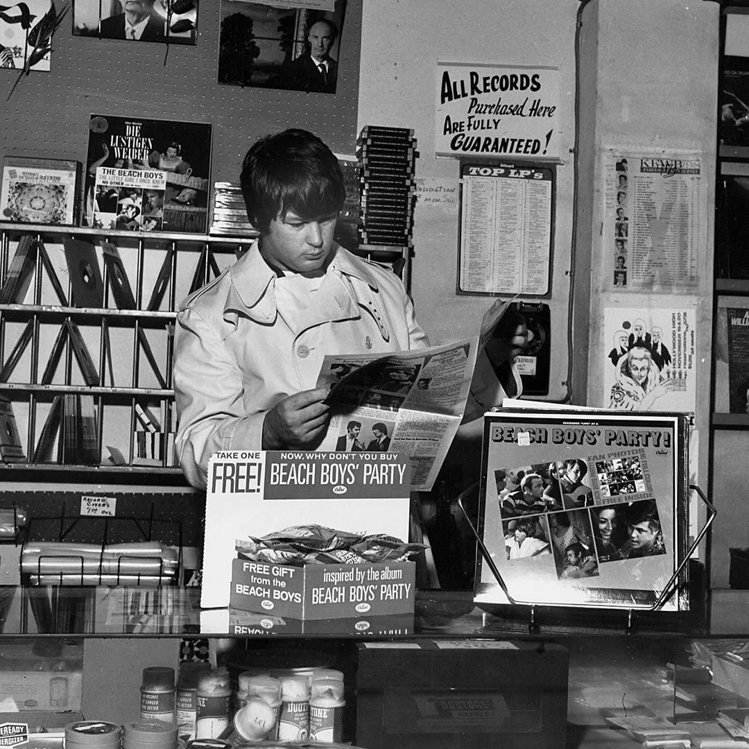 1965: Brian checking out promotions for the new Beach Boys Party! album at a local record shop.