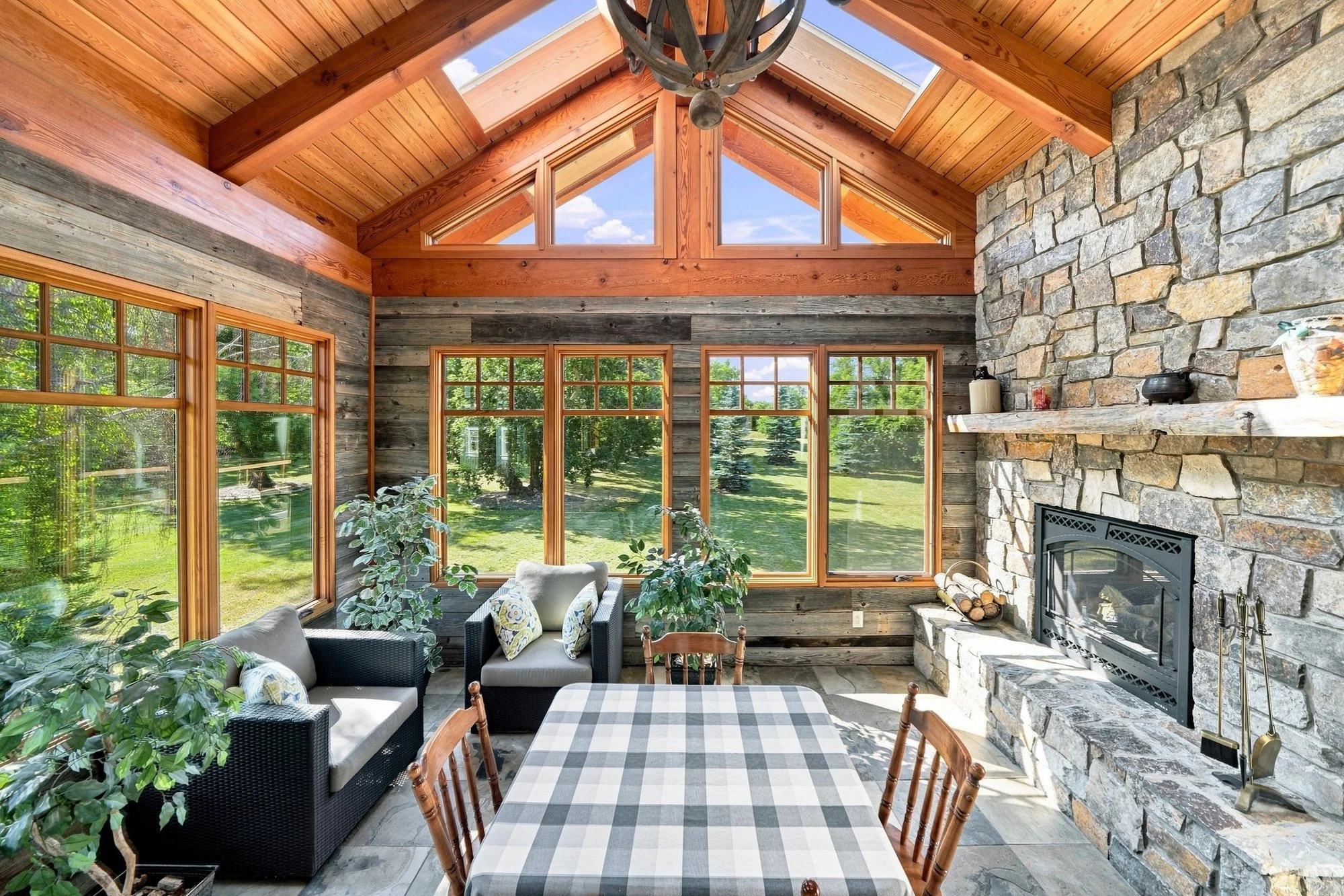 Warm wooden ceiling beams frame the sunroom.jpg