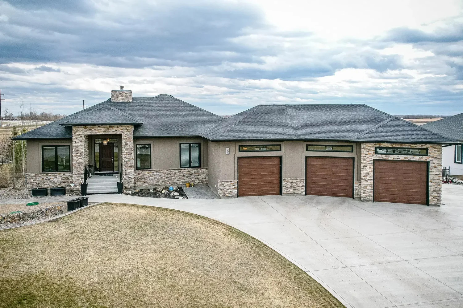 Professional exterior photograph of a modern bungalow listing in Saskatchewan