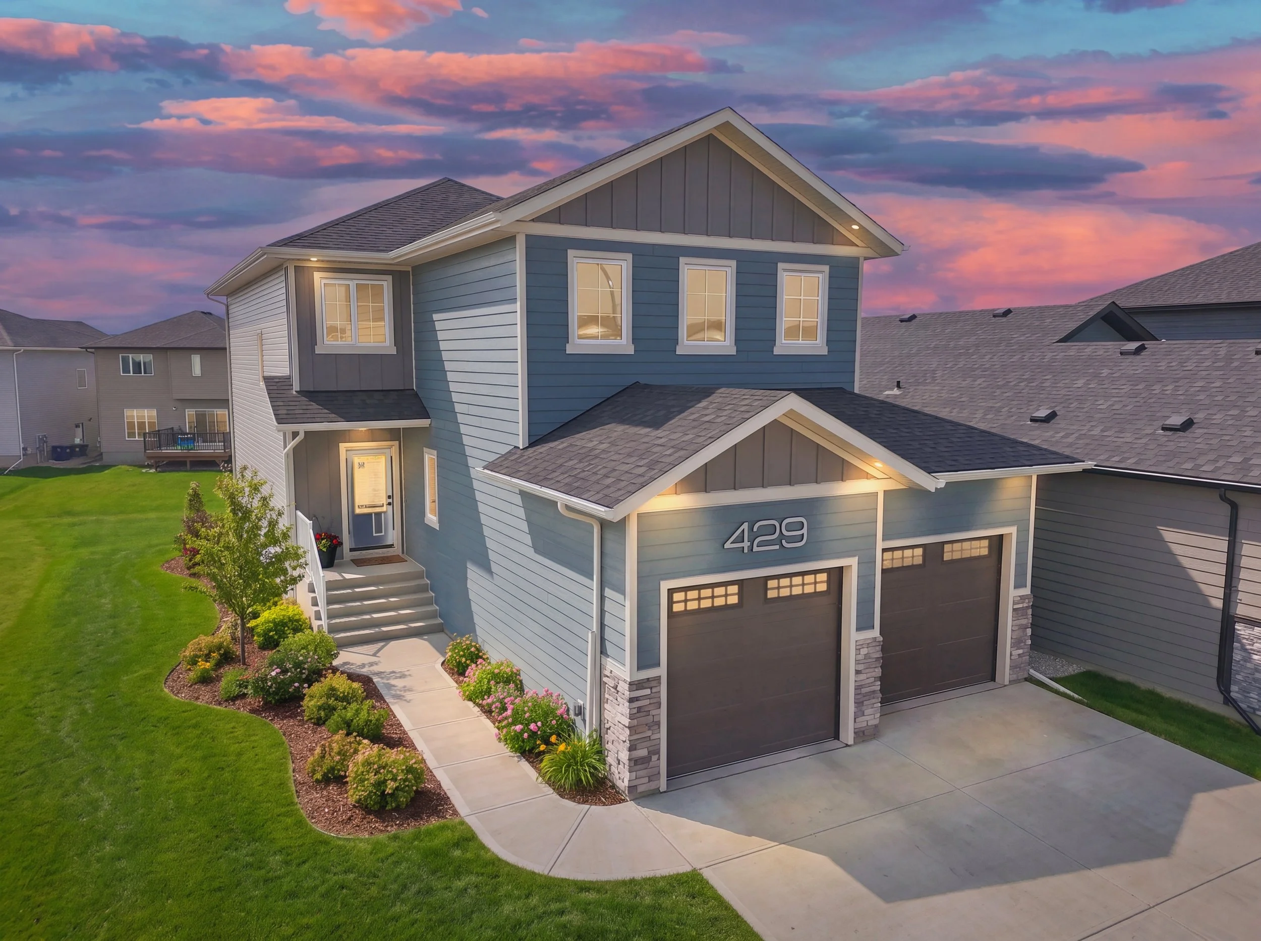 Twilight exterior photograph of a professionally landscaped two-storey home