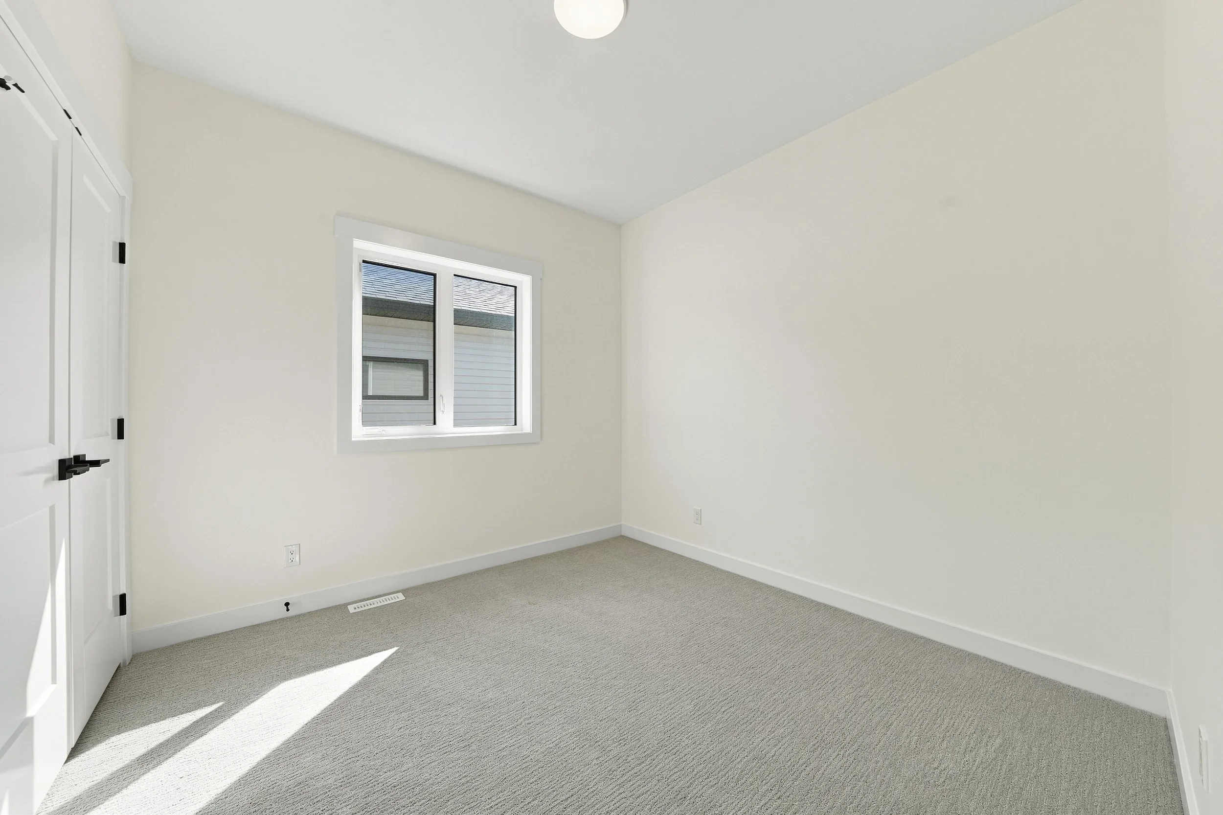 Empty secondary bedroom before virtual staging for real estate marketing
