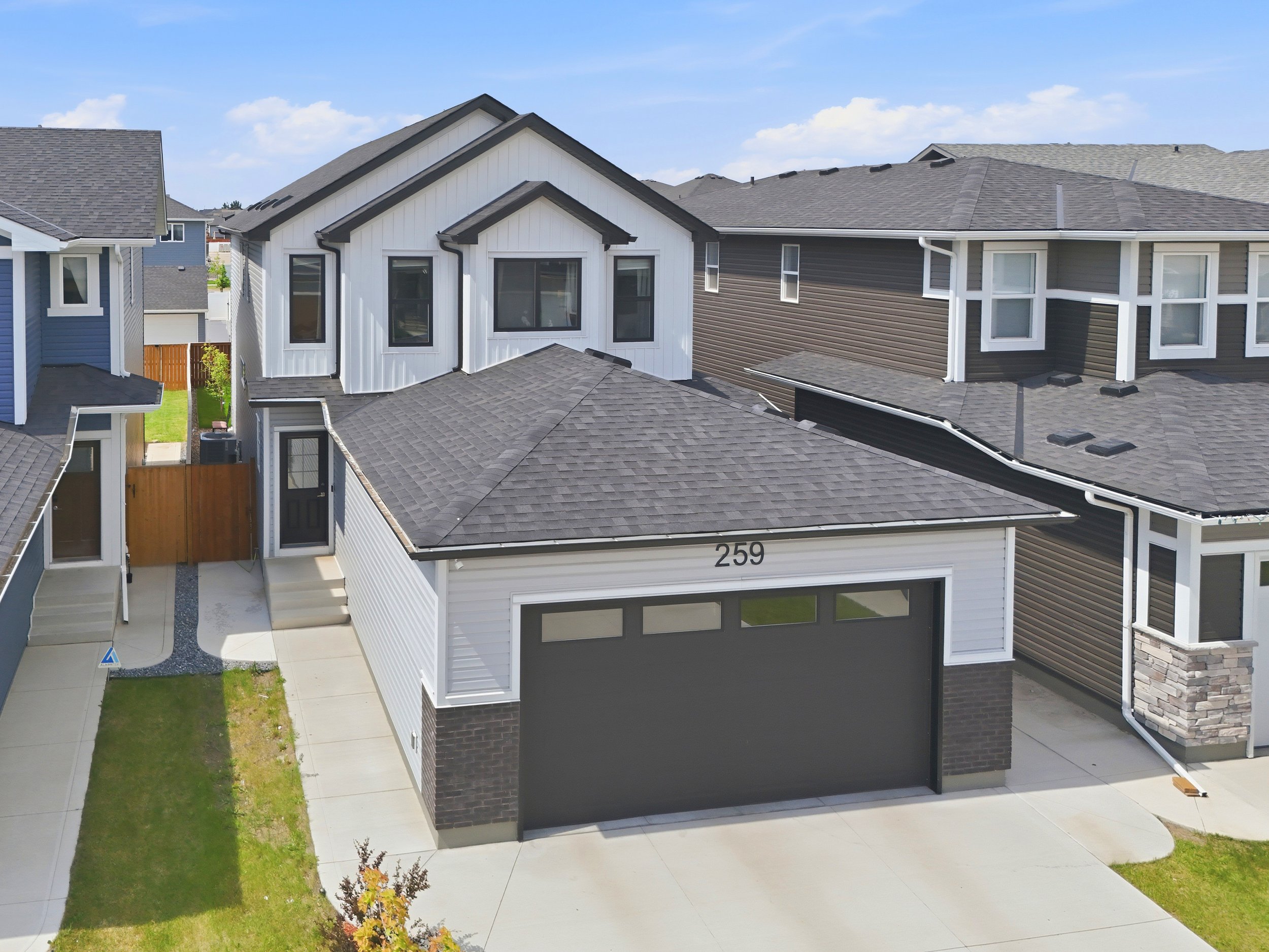 Professional drone photography of a modern residential home in Saskatoon showcasing the exterior, roofline, and surrounding neighbourhood.