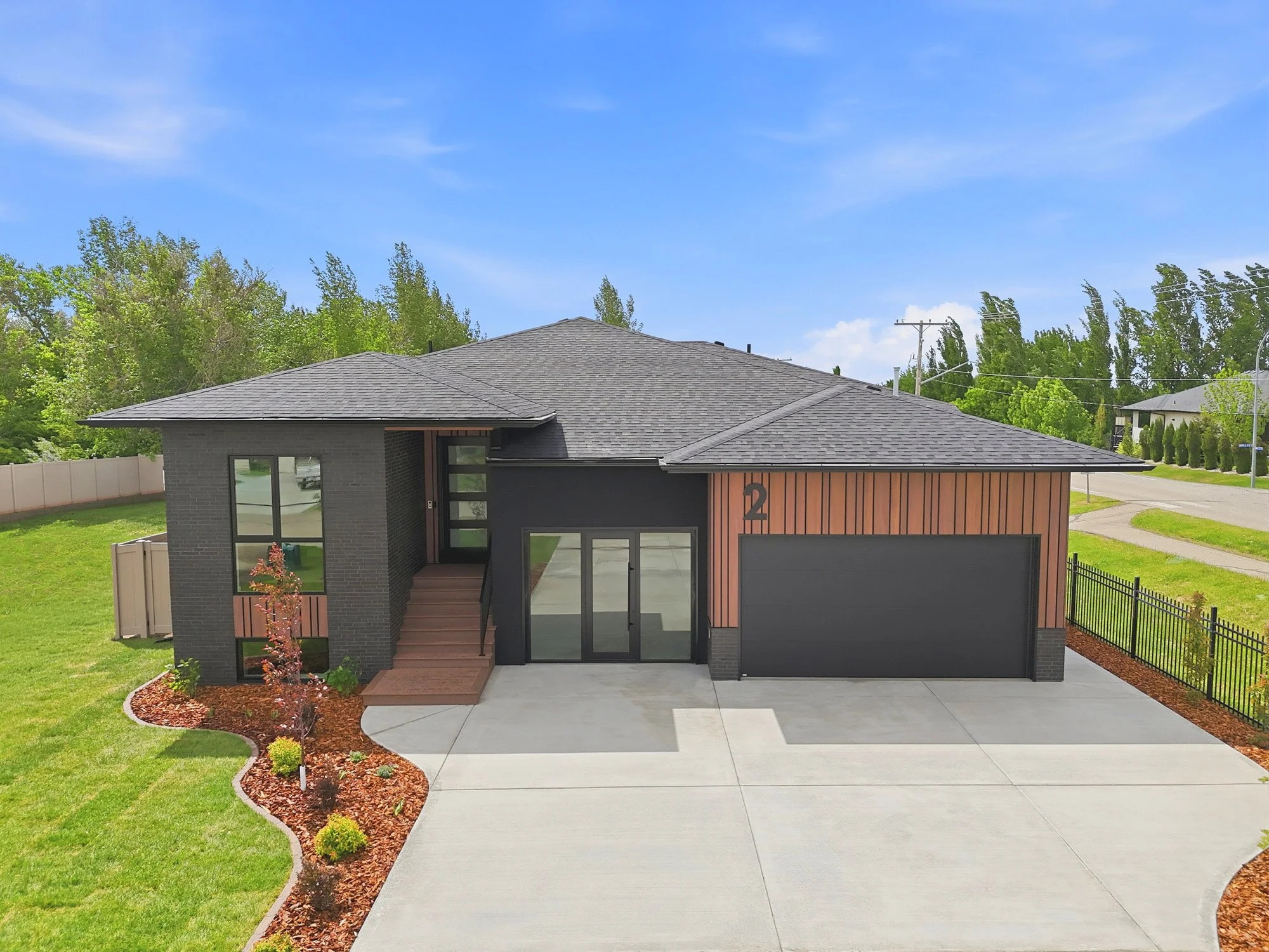 Professional real estate and aerial photography showcasing a modern Saskatoon home’s architecture, landscaping and curb appeal.