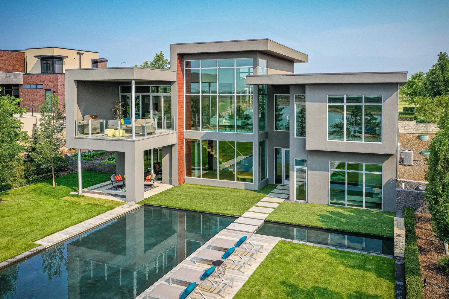 Aerial view of a luxury home's backyard with swimming pool and landscaped outdoor living area.
