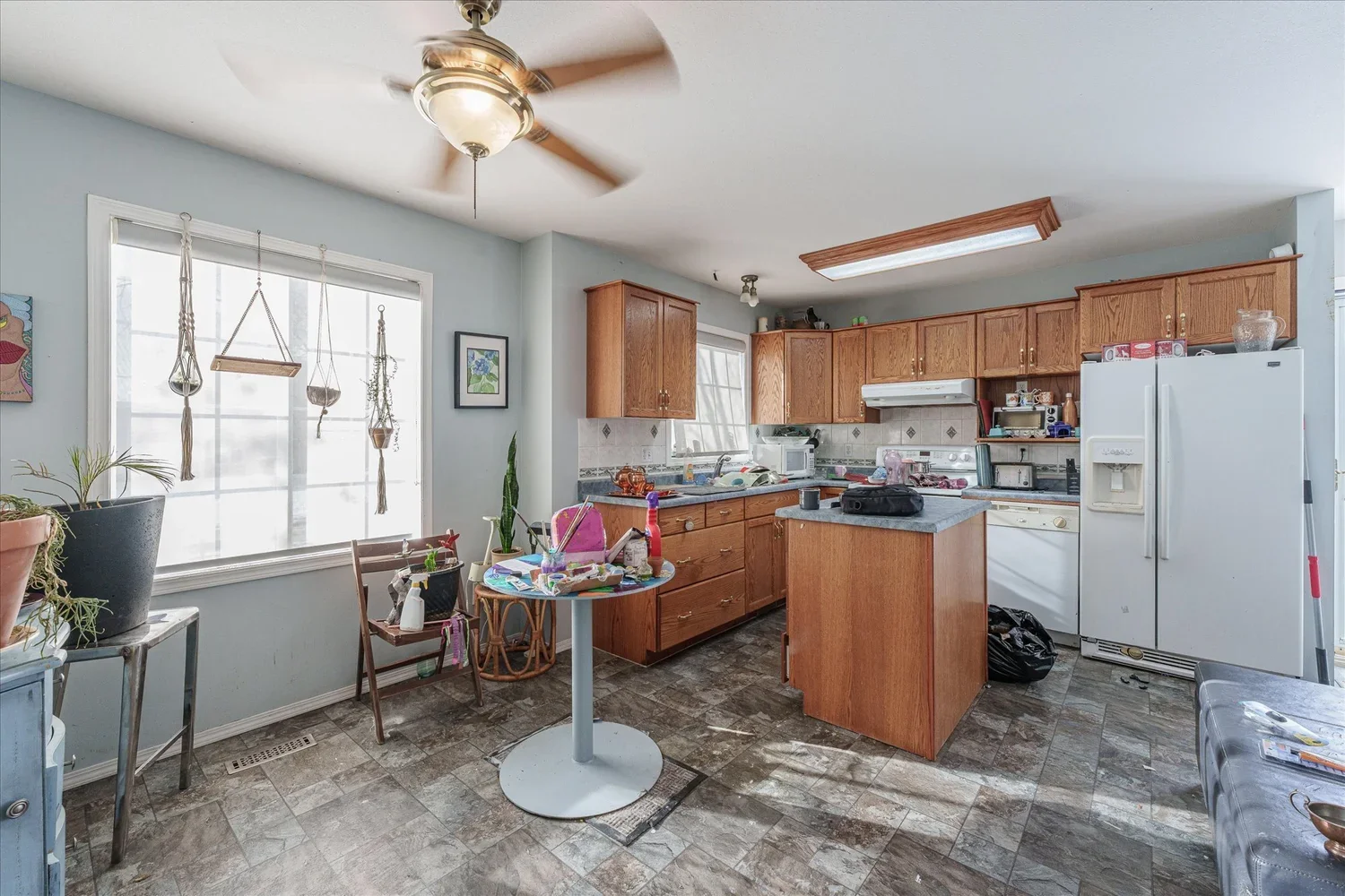 Cluttered kitchen and dining area before staging a home for real estate photography.