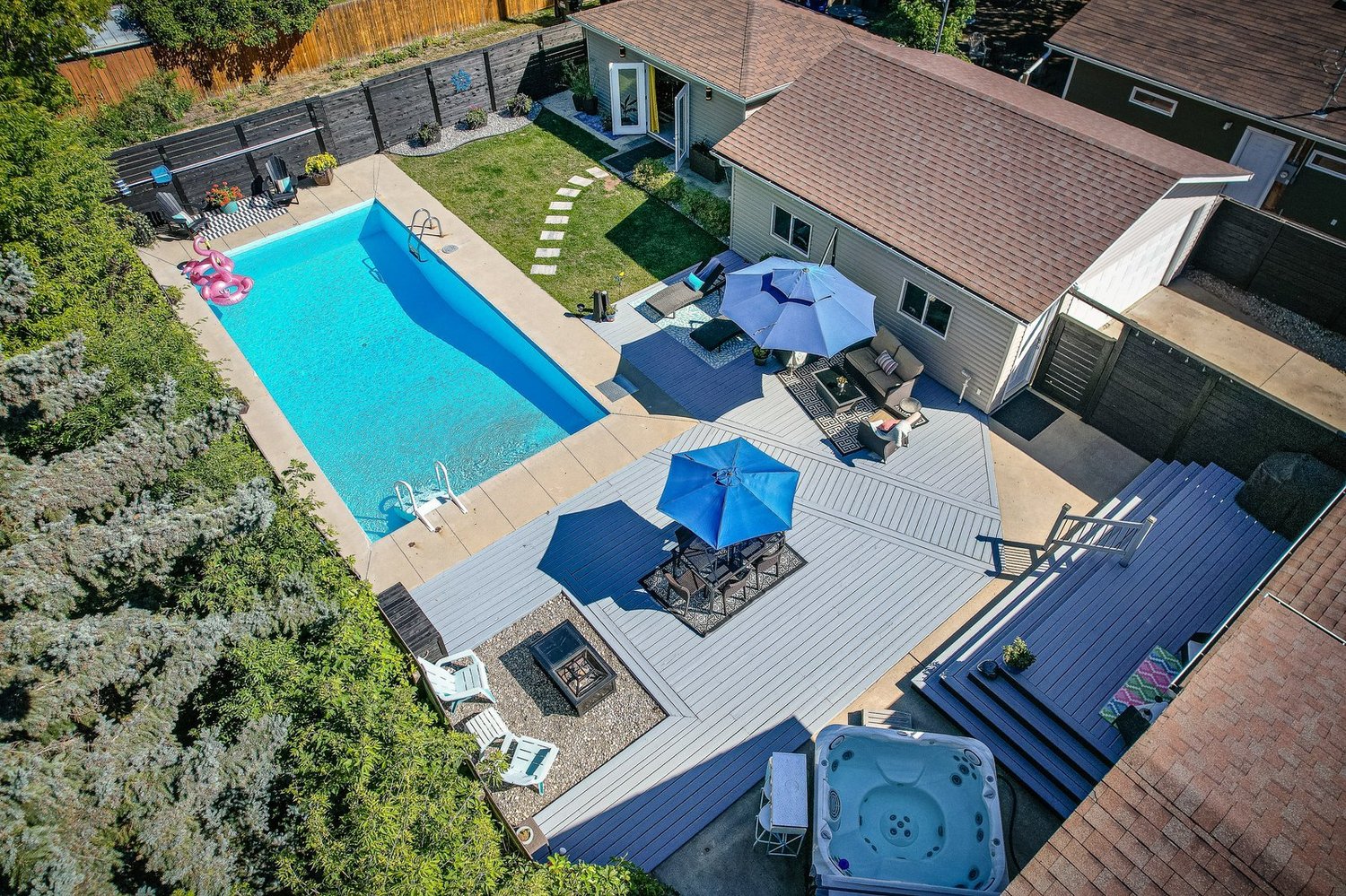 Aerial view of a residential property with a landscaped backyard and swimming pool