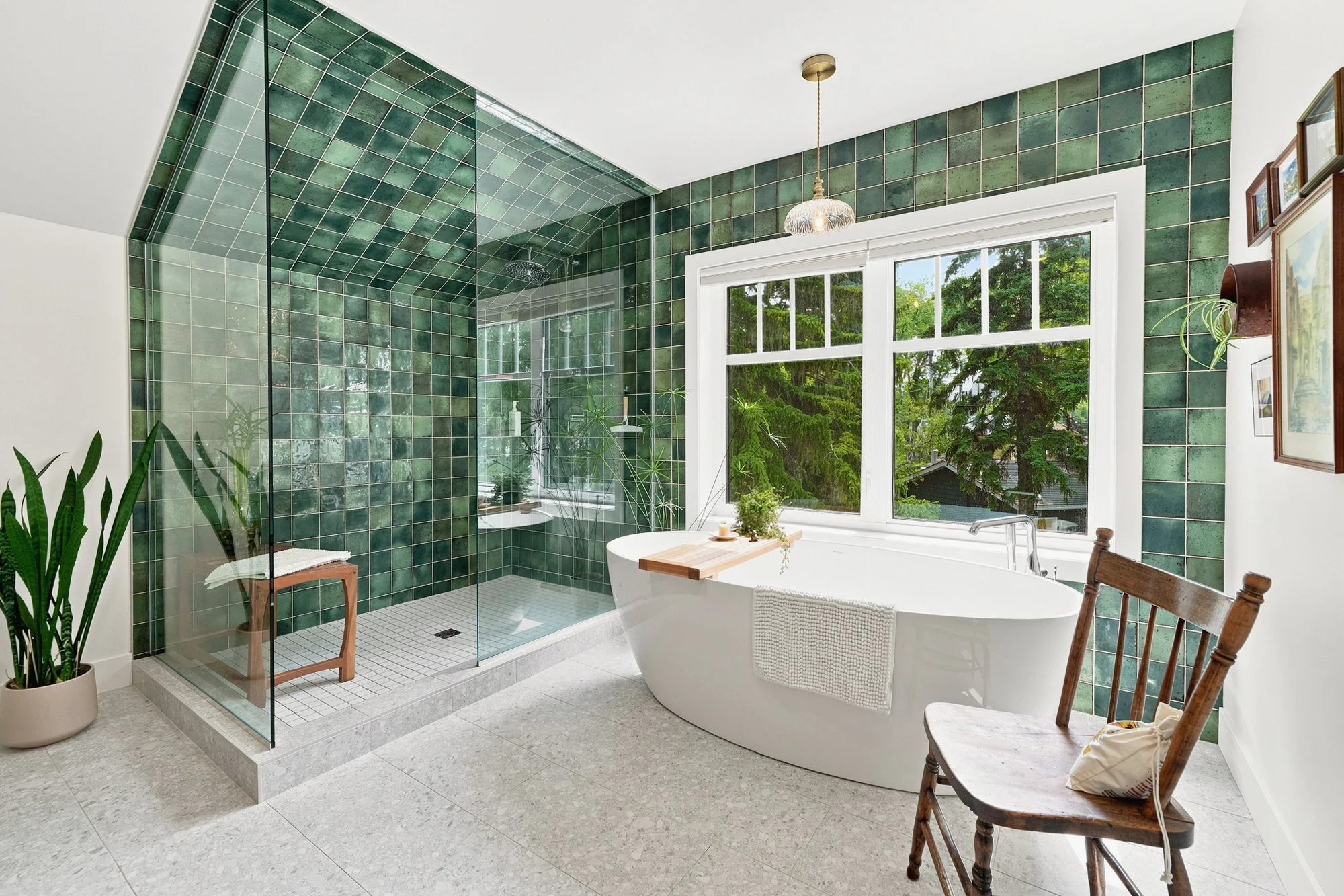 Modern bathroom features green mosaic tile walls.jpg