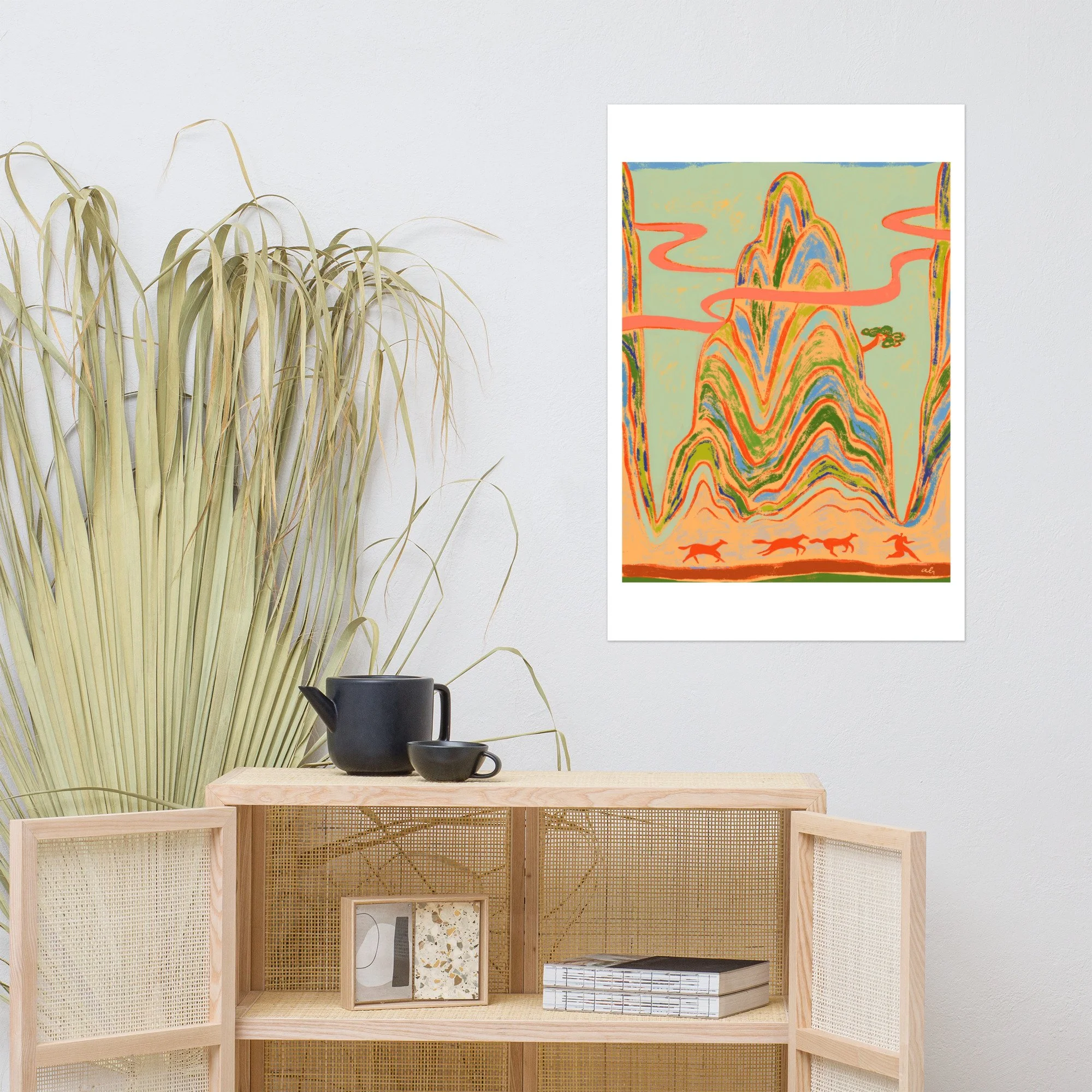 Woman running ahead of wild horses with towering mountains behind.