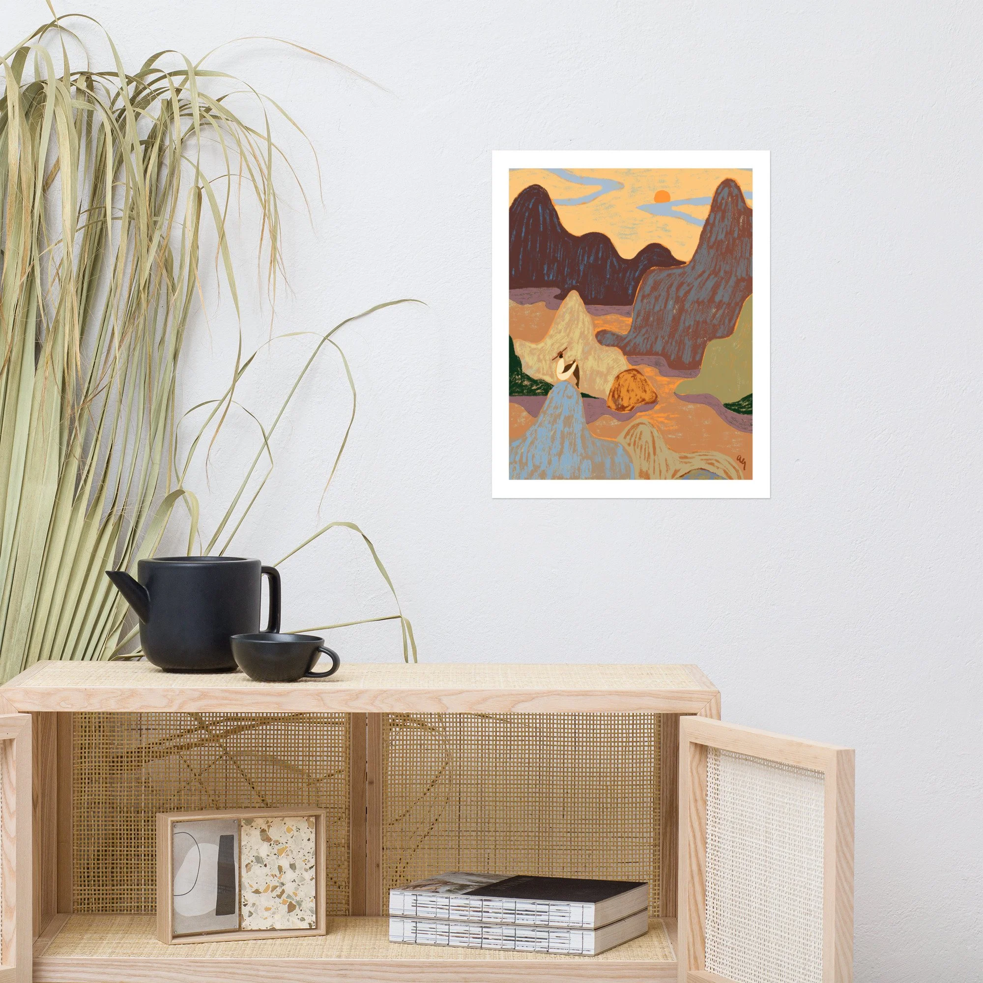 Woman sitting atop a mountain gazing up at the sky.