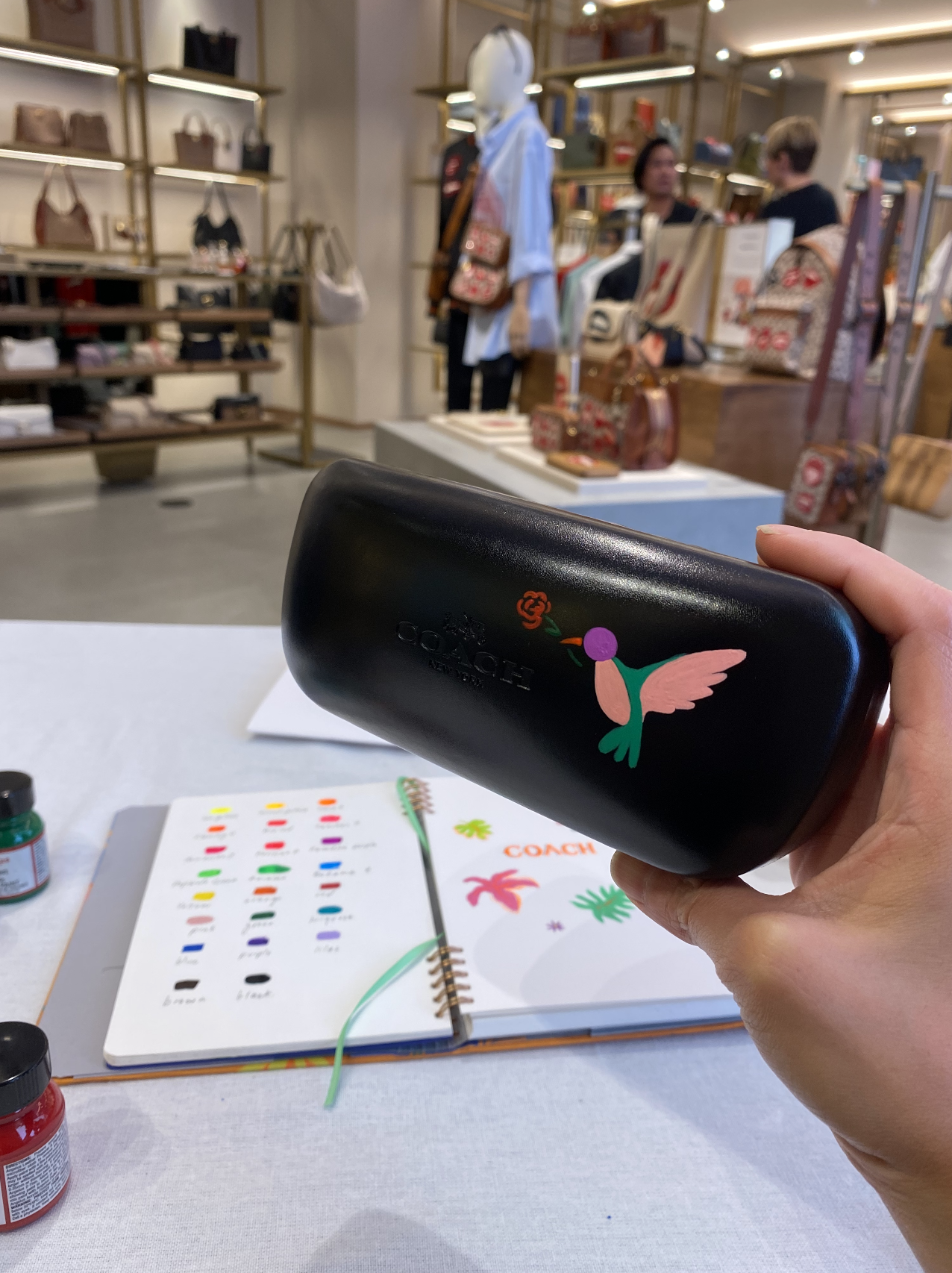 Explore the vibrant Arty Guava x COACH collaboration, blending whimsical art with high-end fashion. Custom paintings and calligraphy elevate COACH bags and apparel.