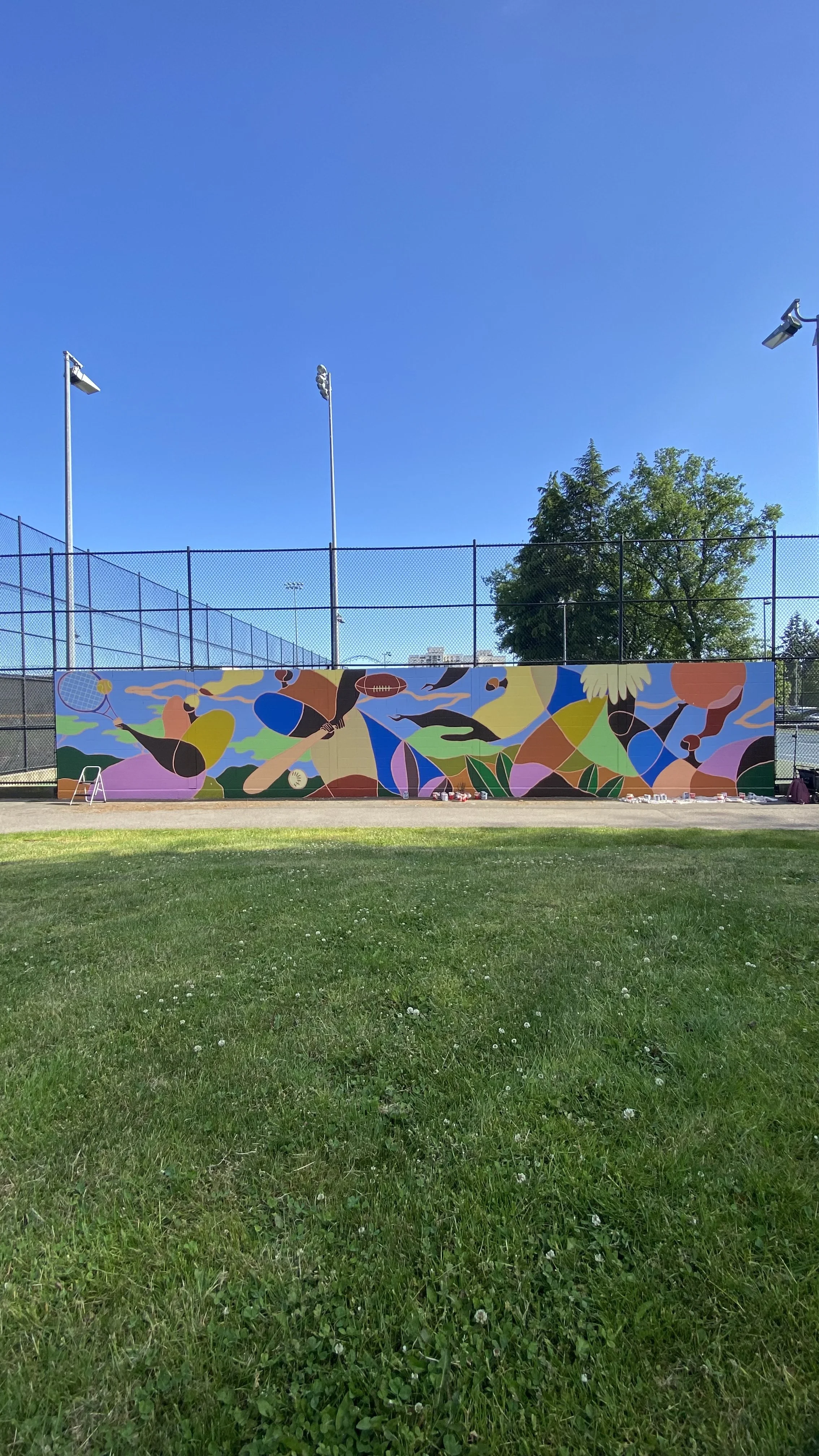 Arty Guava mural at Minoru Park Tennis Court in Richmond, featuring vibrant colours and joyful figures inspired by movement, sport, and community in a public outdoor space.