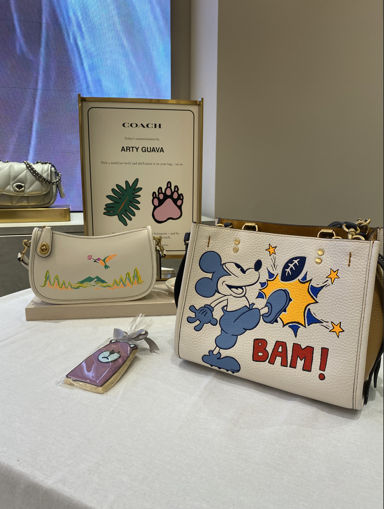 Bold, colorful art by Arty Guava adds a playful touch to COACH’s luxury accessories, making this collaboration perfect for clients seeking unique, artistic fashion designs.