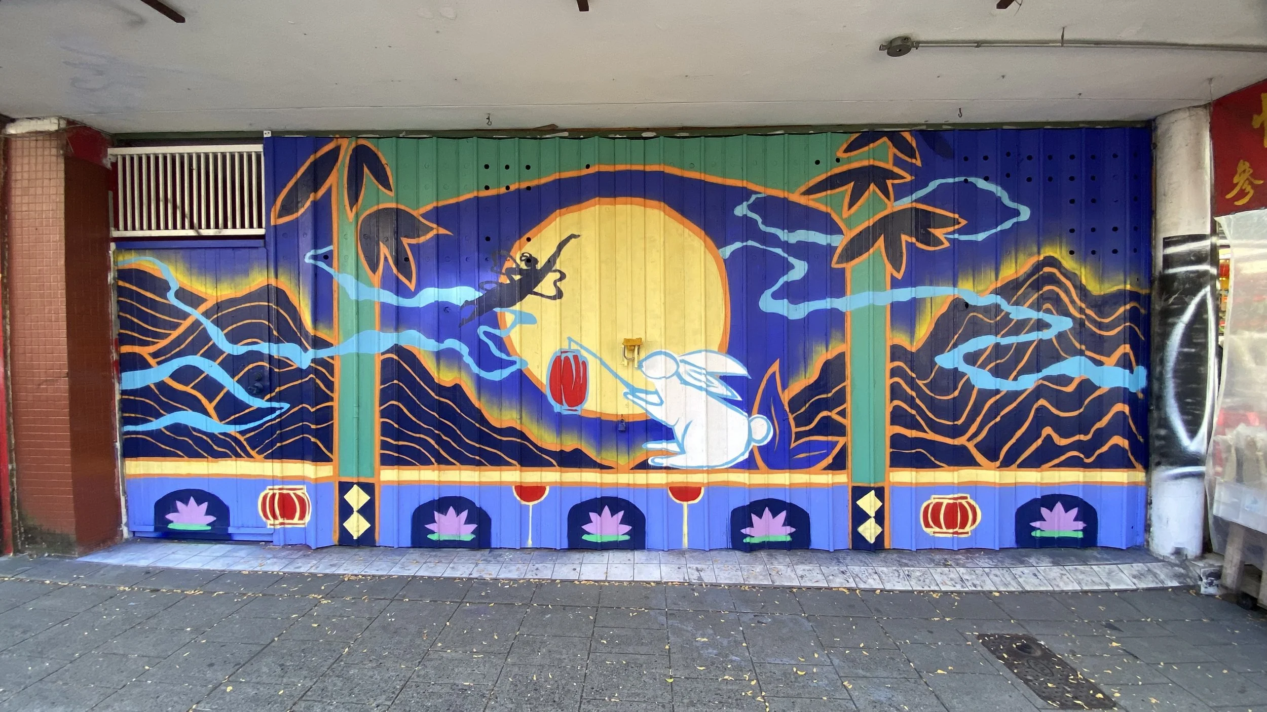 Arty Guava Chinatown mural inspired by the Mid-Autumn Festival, featuring vibrant colours, flowing figures, and symbolic elements celebrating reunion, moonlight, and cultural heritage.