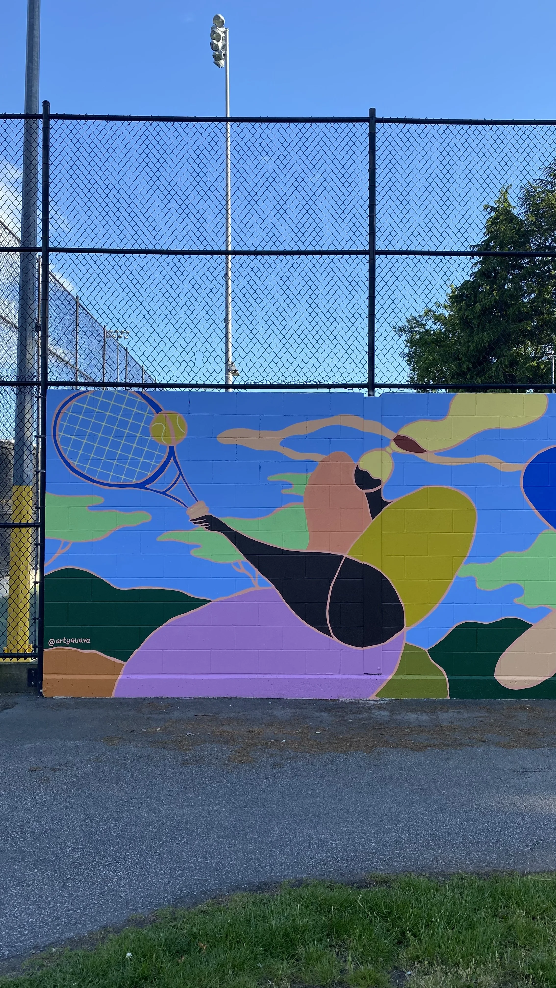Arty Guava mural at Minoru Park Tennis Court in Richmond, featuring vibrant colours and joyful figures inspired by movement, sport, and community in a public outdoor space.