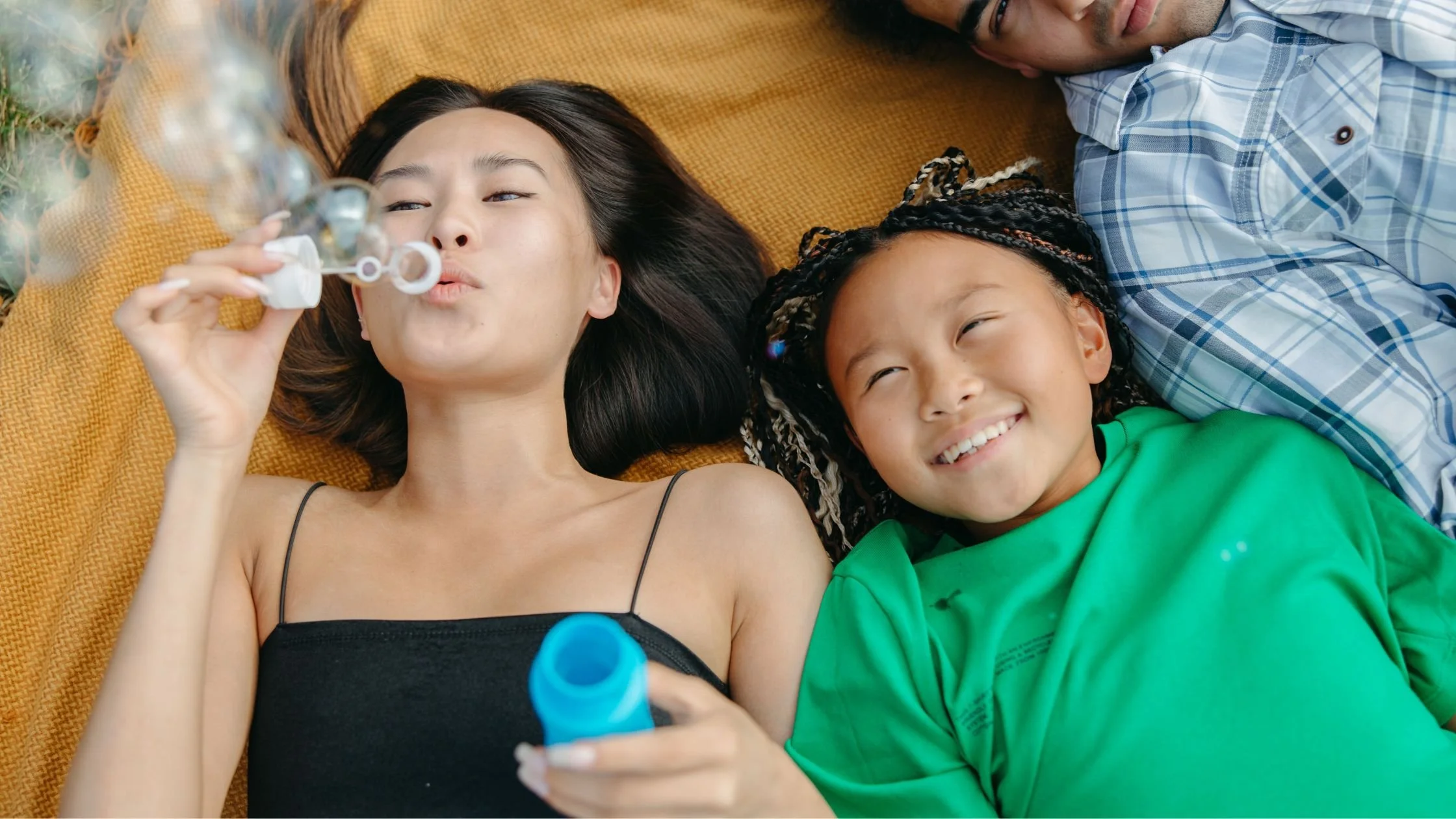 summer family fun blowing bubbles in the park