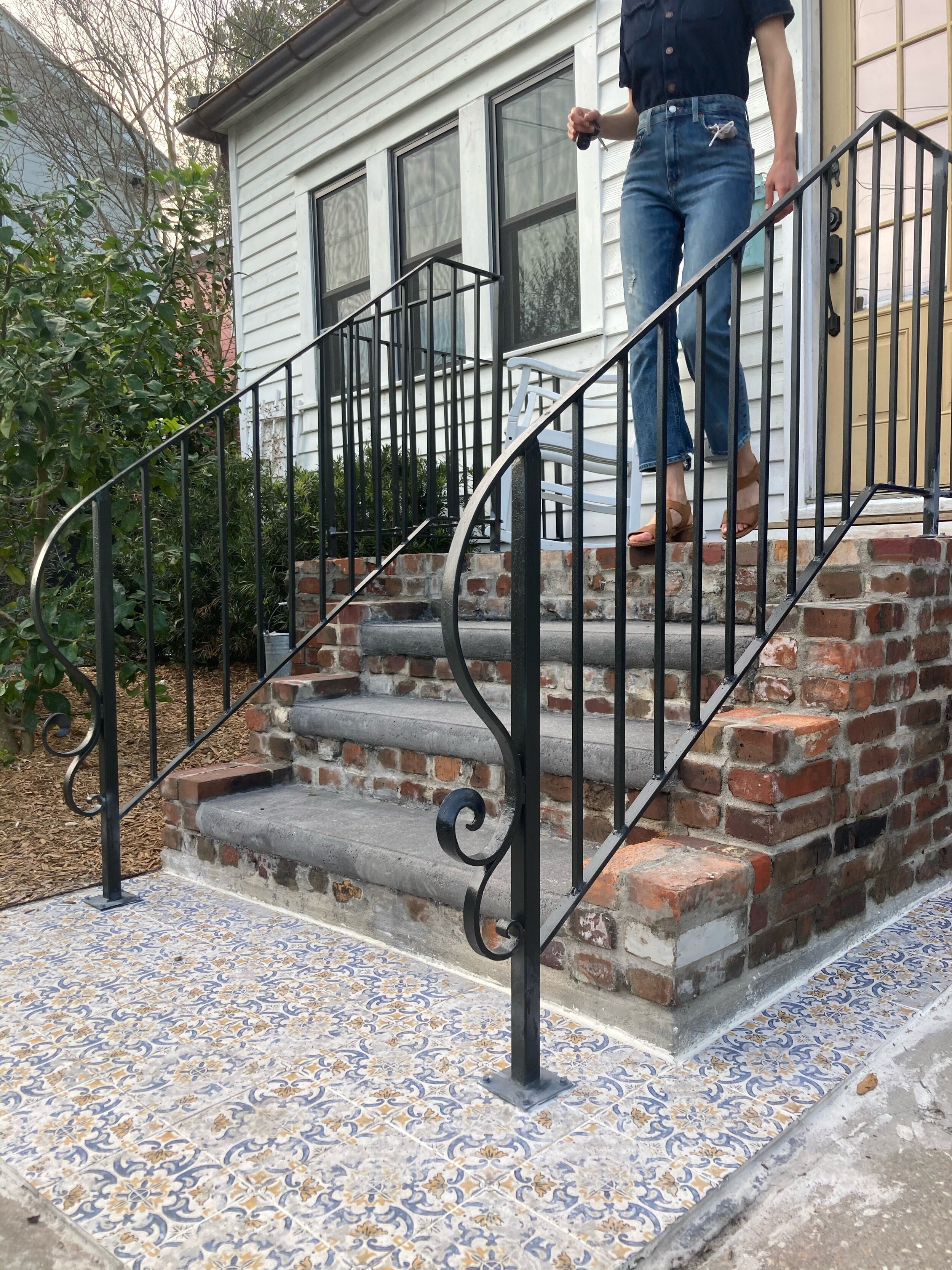 Custom tiling with a custom made brick concrete porch
