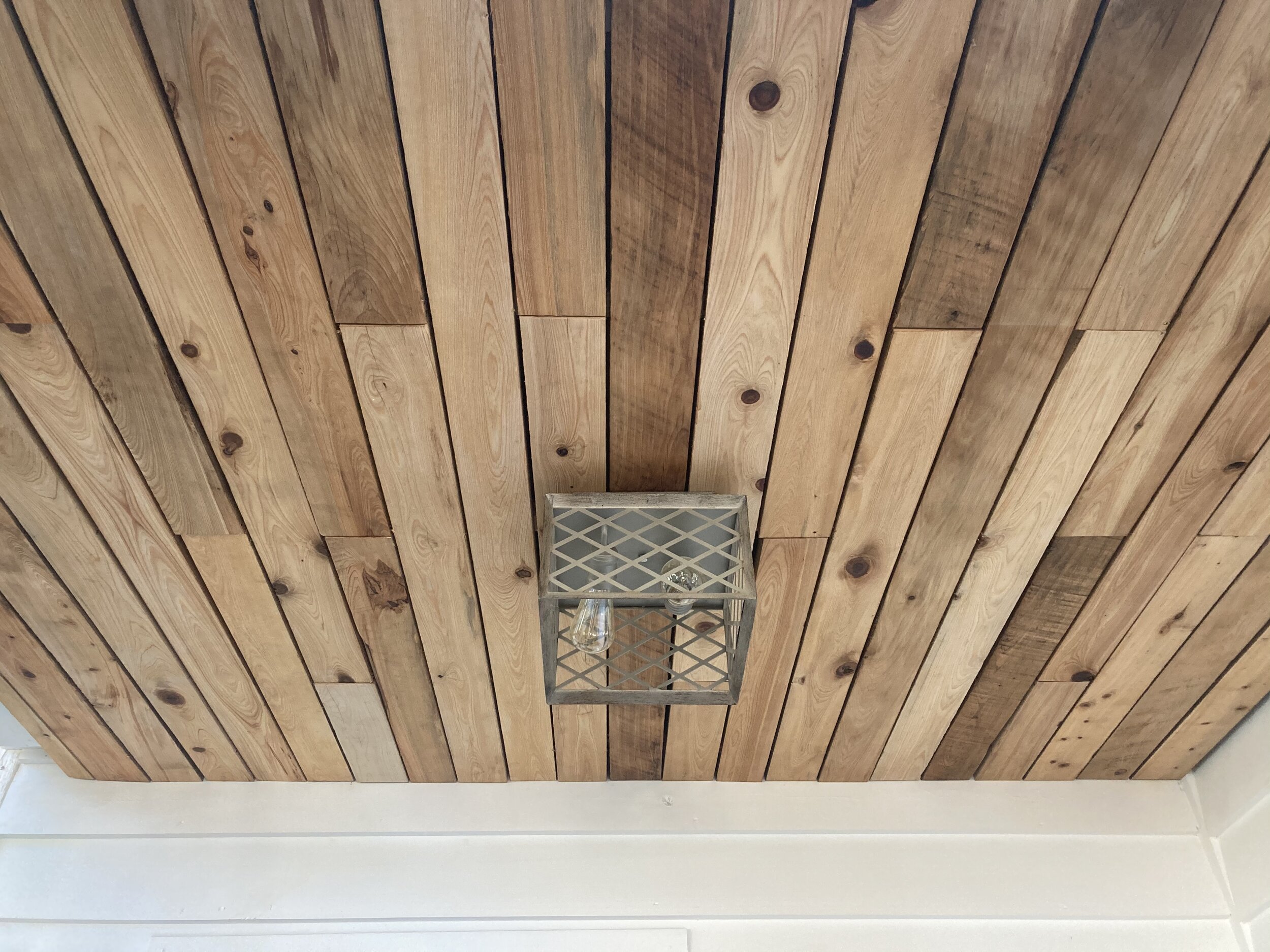Cedar wood panels on ceiling of custom made porch