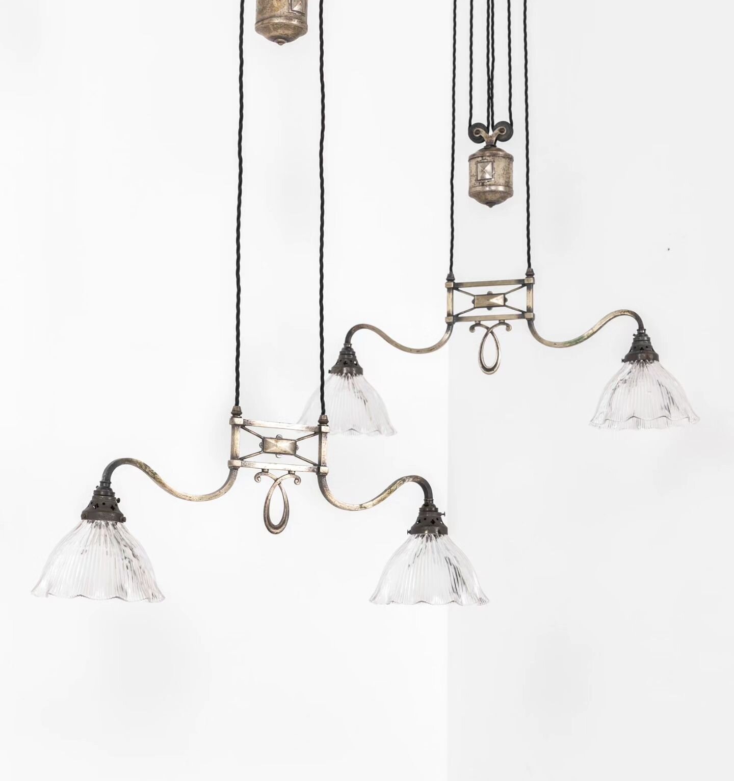 A pair of early 20th century rise and fall ceiling lights by GEC in their original oxidised silver finish, complemented by period glass Holophane shades. 

#antiquesworkshop #vintageindustrial #antique #vintage #midcentury #antiques #midcenturymodern