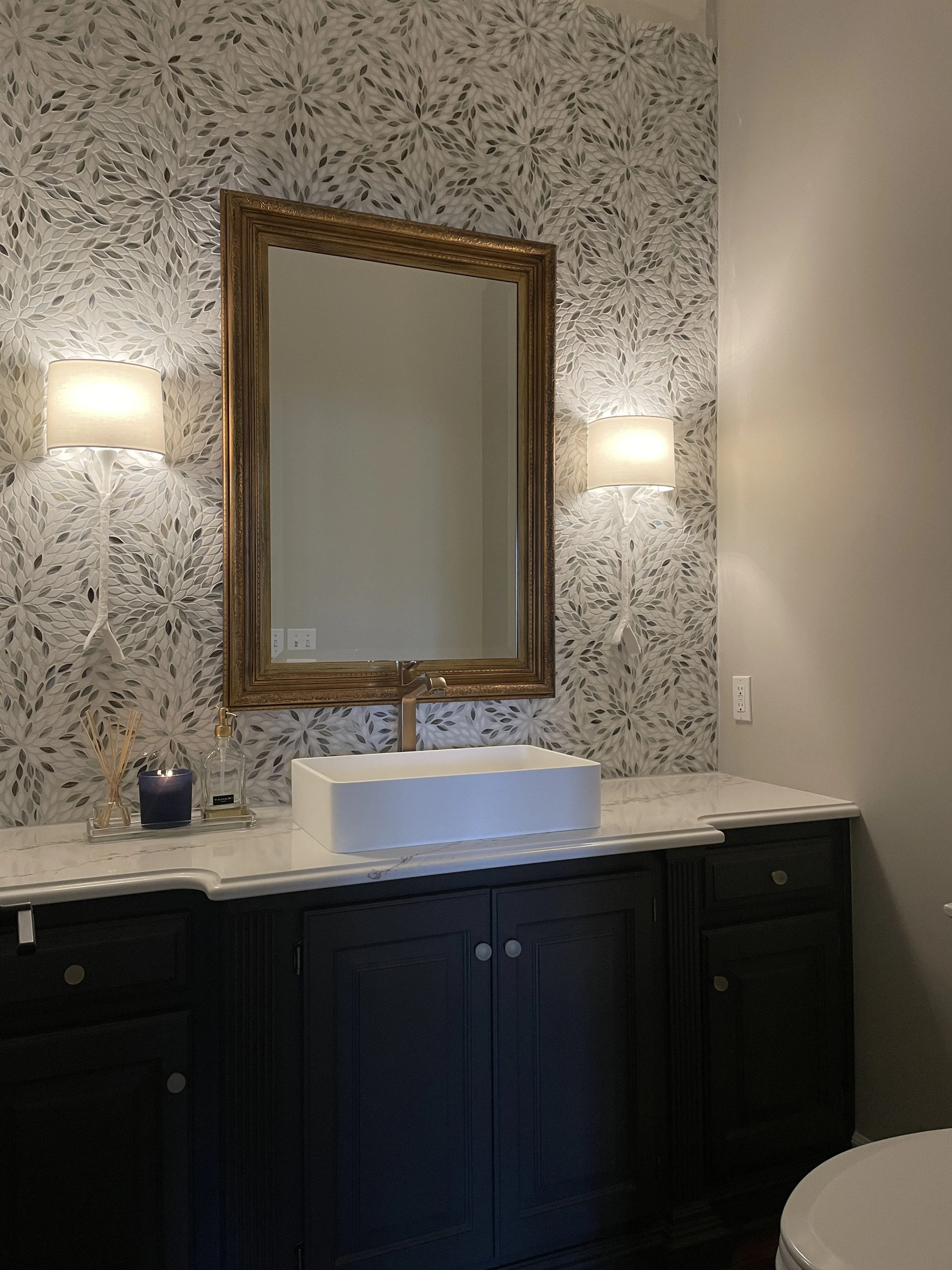 Transitional Powder Bathroom Remodel Design by Singer Interiors in Venice Florida with Quartz Counters & Visual Comfort Sconces