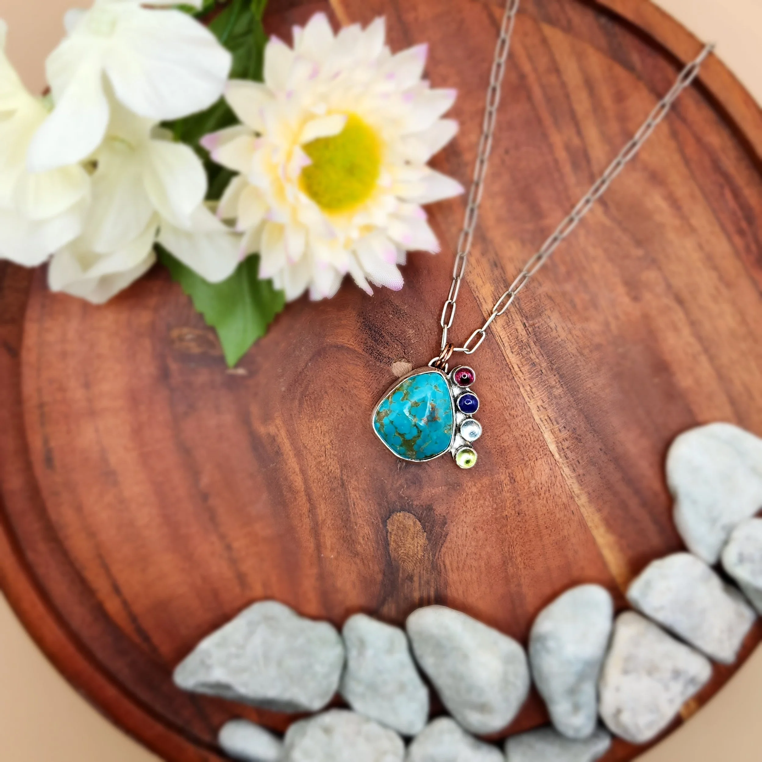 Custom sterling silver necklace with turquoise and birthstones stones selected by the client. Fire and Fringe artisan jewelry highlighting personalized, handmade designs in Caldwell, Idaho.