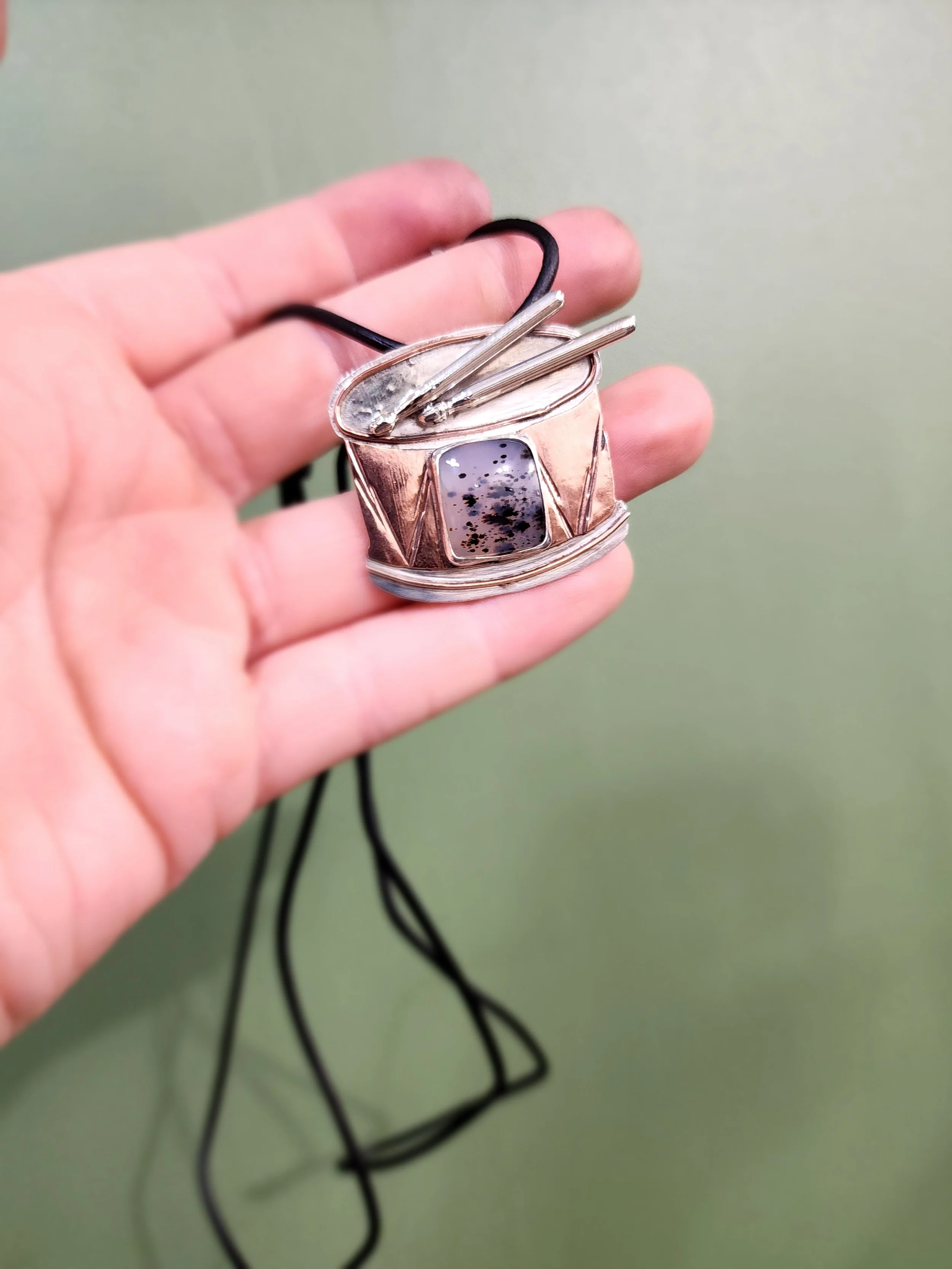Close-up of a sentimental custom pendant with unique mixed metal design and customer provided stone. Handmade by Fire and Fringe, perfect for heirloom-quality jewelry gifts