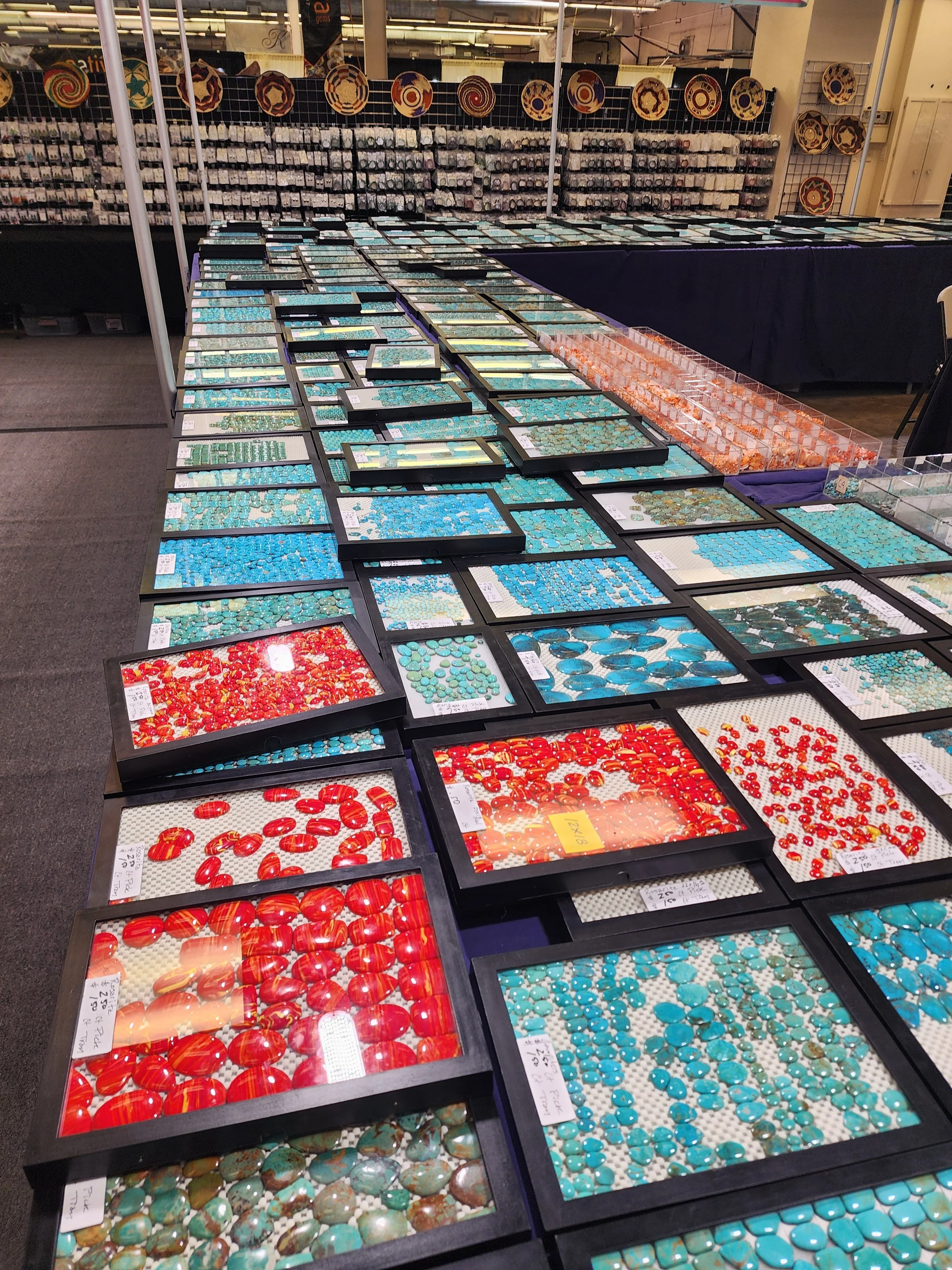 Colorful array of polished stones including amethyst, quartz, and jasper