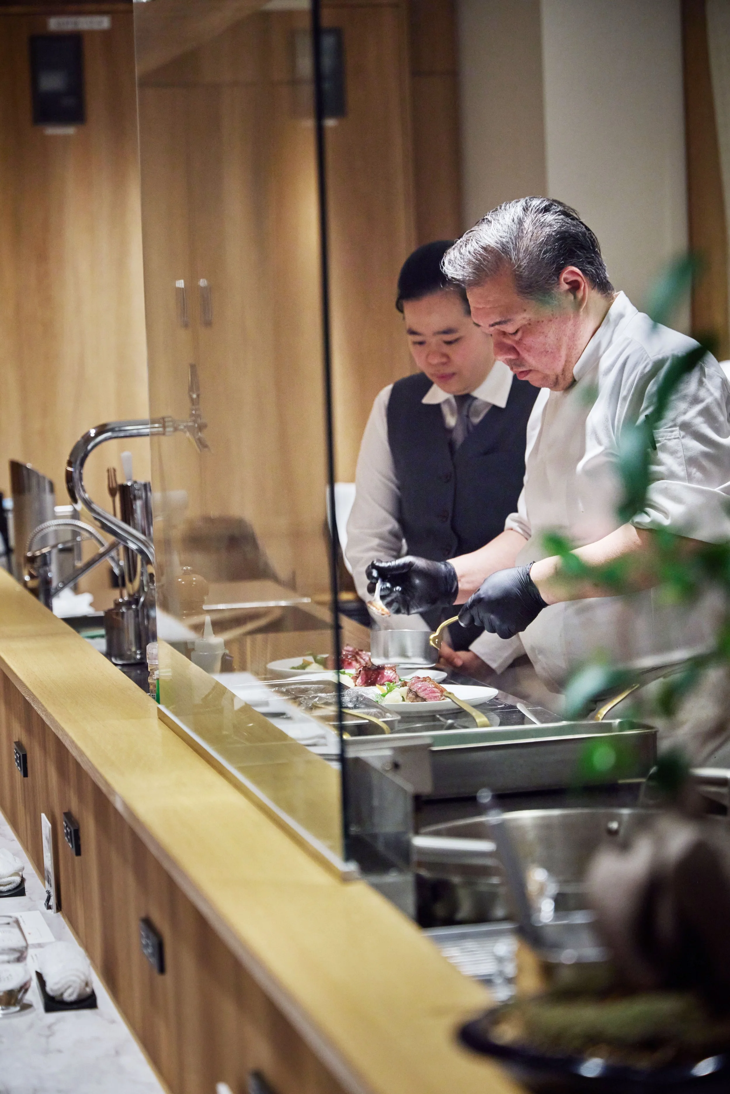Chef pouring sauce on final dish